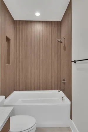 a bathroom with a bathtub and a toilet