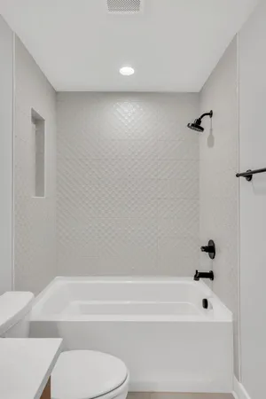 a bathroom with a bathtub and a toilet