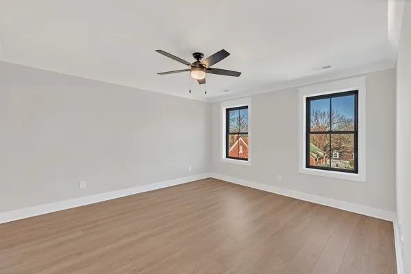wooden floor in an empty room with a window