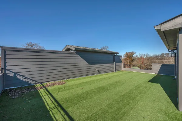 a backyard of a house with table and chairs