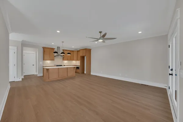 a view of a kitchen with a sink wooden floor and chandelier