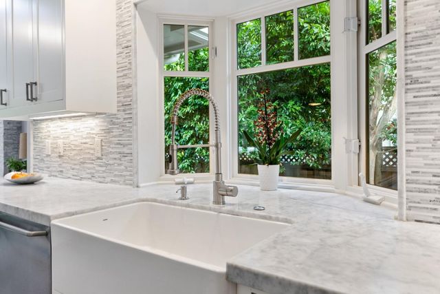 a white bath tub sitting in front of a window