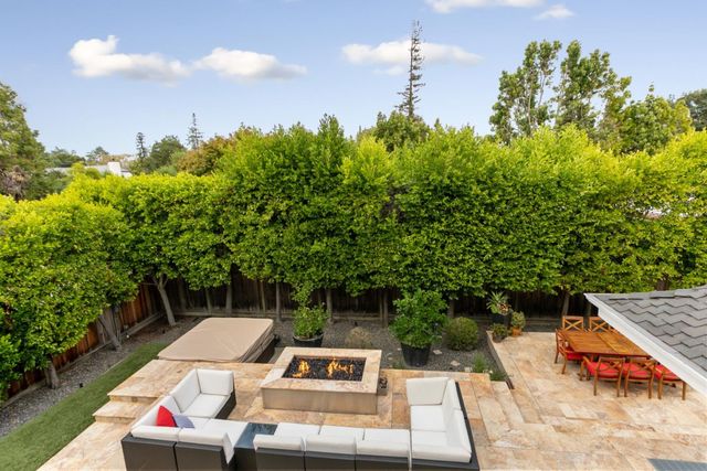 a view of a backyard with plants and a patio