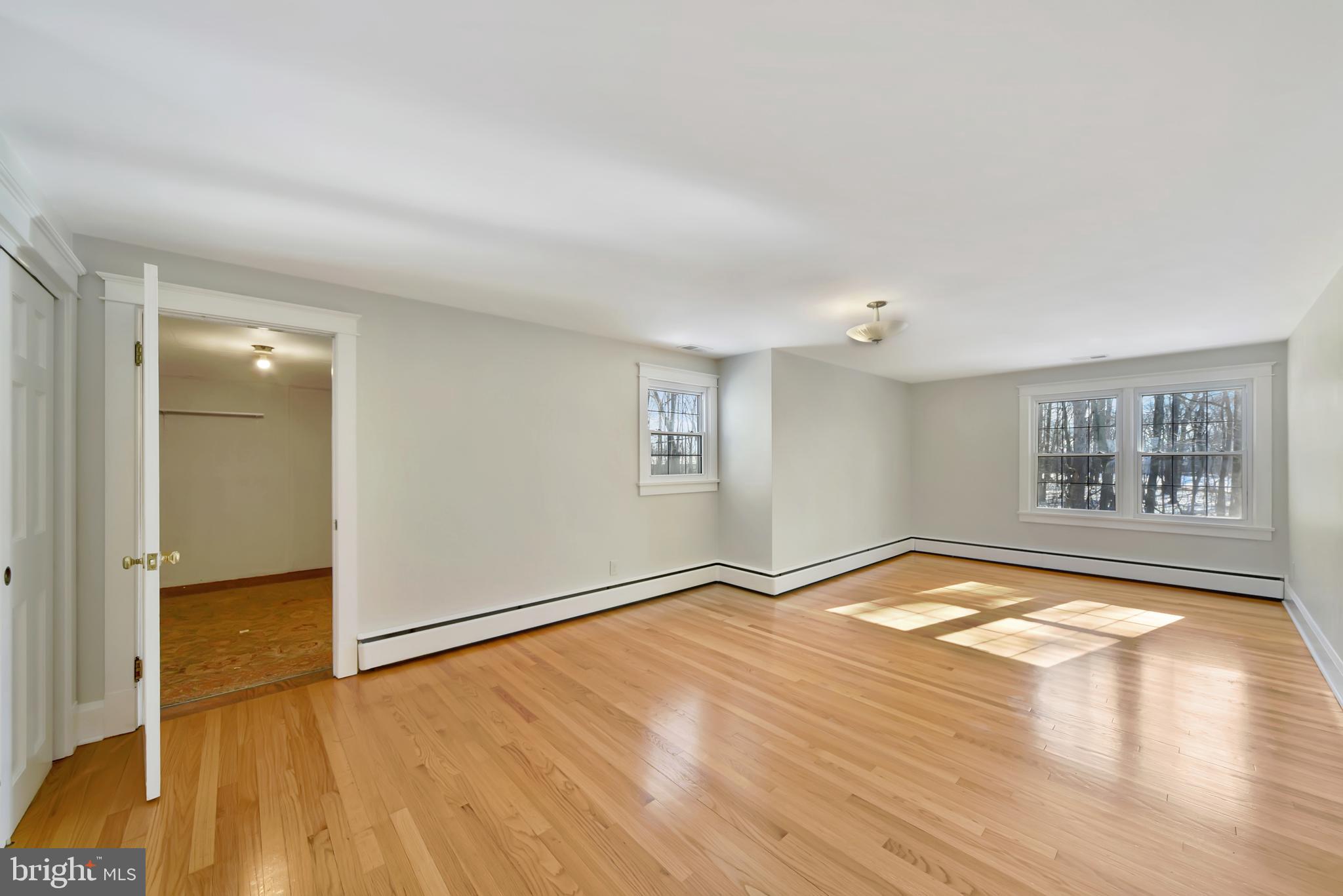 2675 Jolly Acres Road White Hall, MD 21161 - Photo 16 of 50 a view of empty room with wooden floor and fan