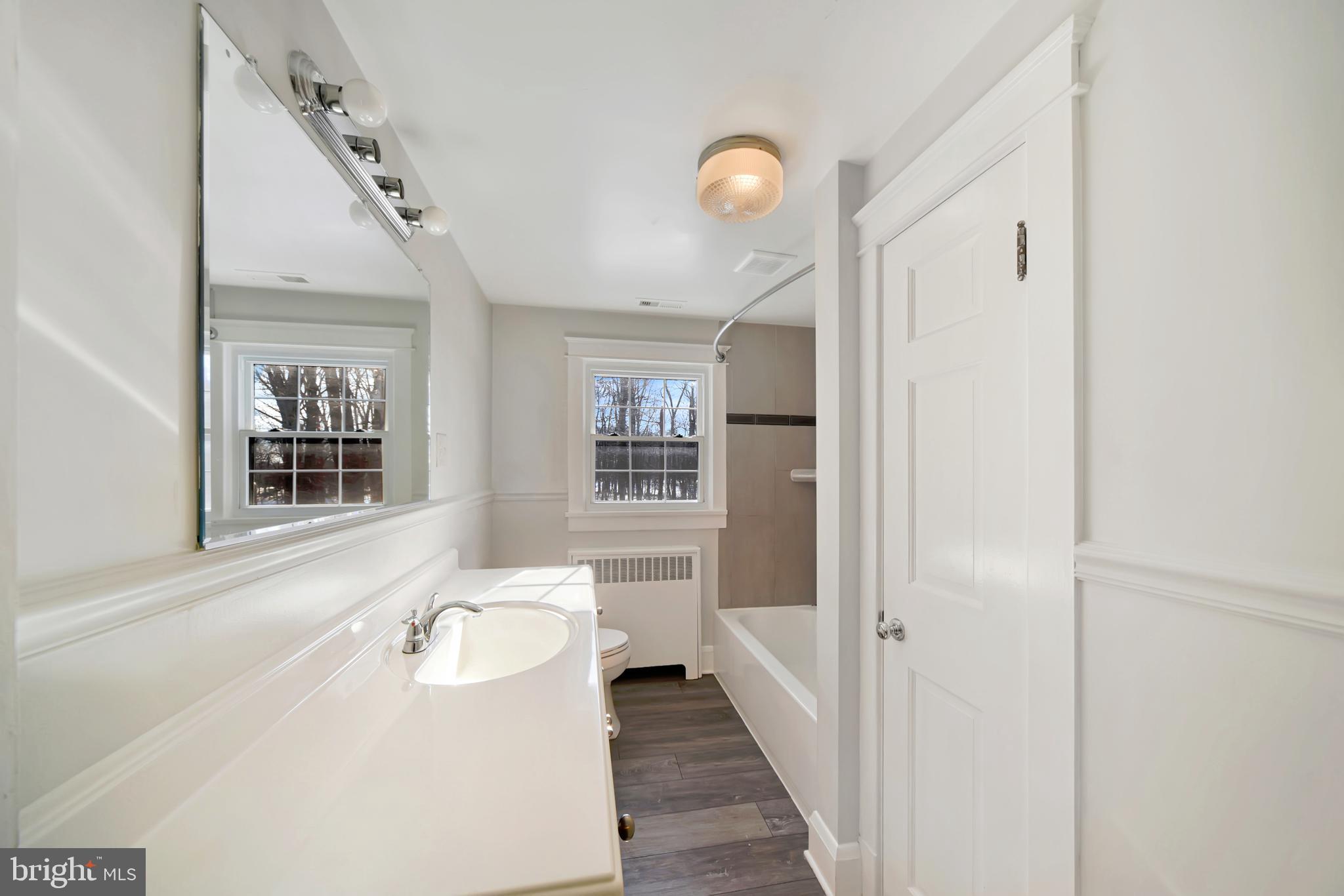 2675 Jolly Acres Road White Hall, MD 21161 - Photo 25 of 50 a bathroom with a sink a mirror and a bathtub