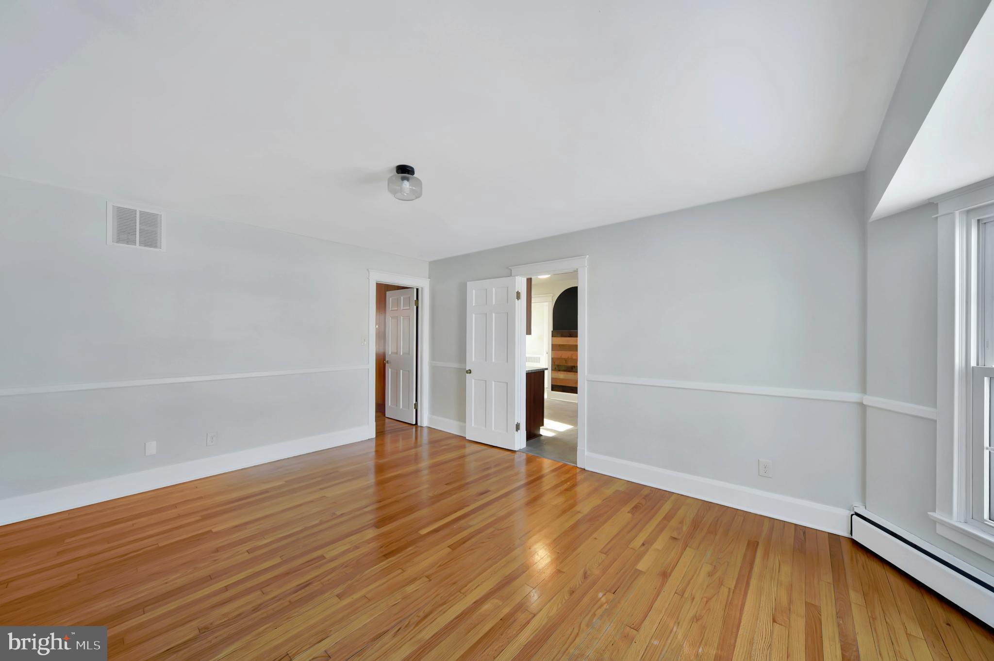2675 Jolly Acres Road White Hall, MD 21161 - Photo 8 of 50 an empty room with wooden floor and windows