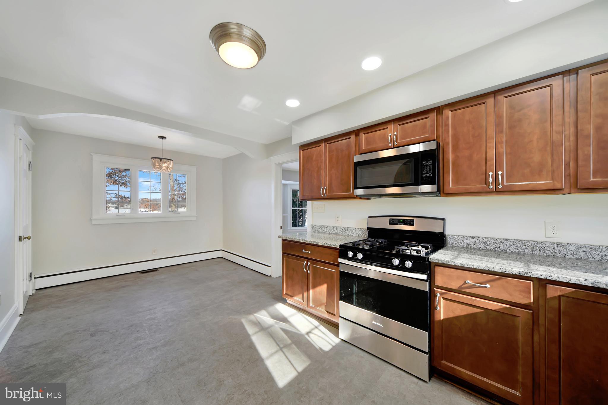 2675 Jolly Acres Road White Hall, MD 21161 - Photo 10 of 50 a kitchen with granite countertop a stove top oven sink and cabinets
