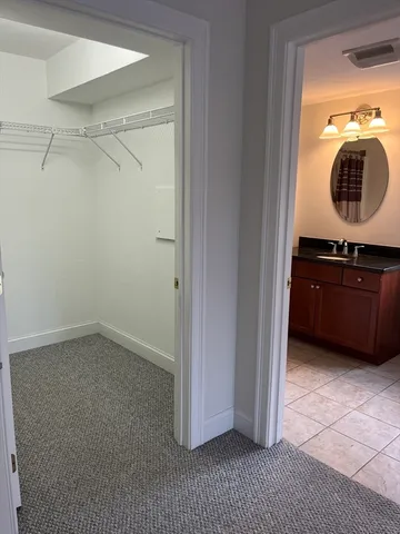 a view of a cabinet and a mirror in a room