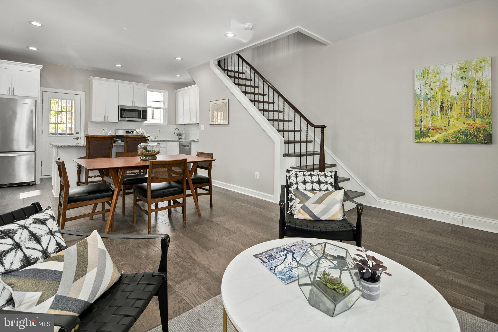 713 Rittenhouse Street Northwest Washington, DC 20011 - Photo 15 of 35 a living room with furniture a dining table and kitchen view with wooden floor