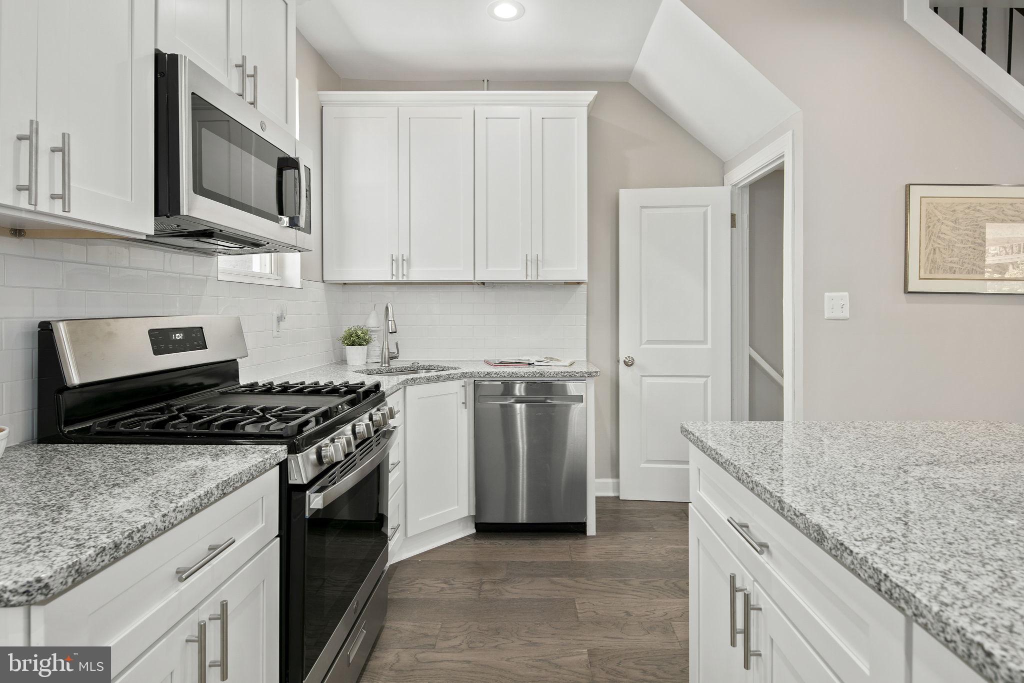 713 Rittenhouse Street Northwest Washington, DC 20011 - Photo 21 of 35 a kitchen with stainless steel appliances granite countertop a stove a sink and a microwave