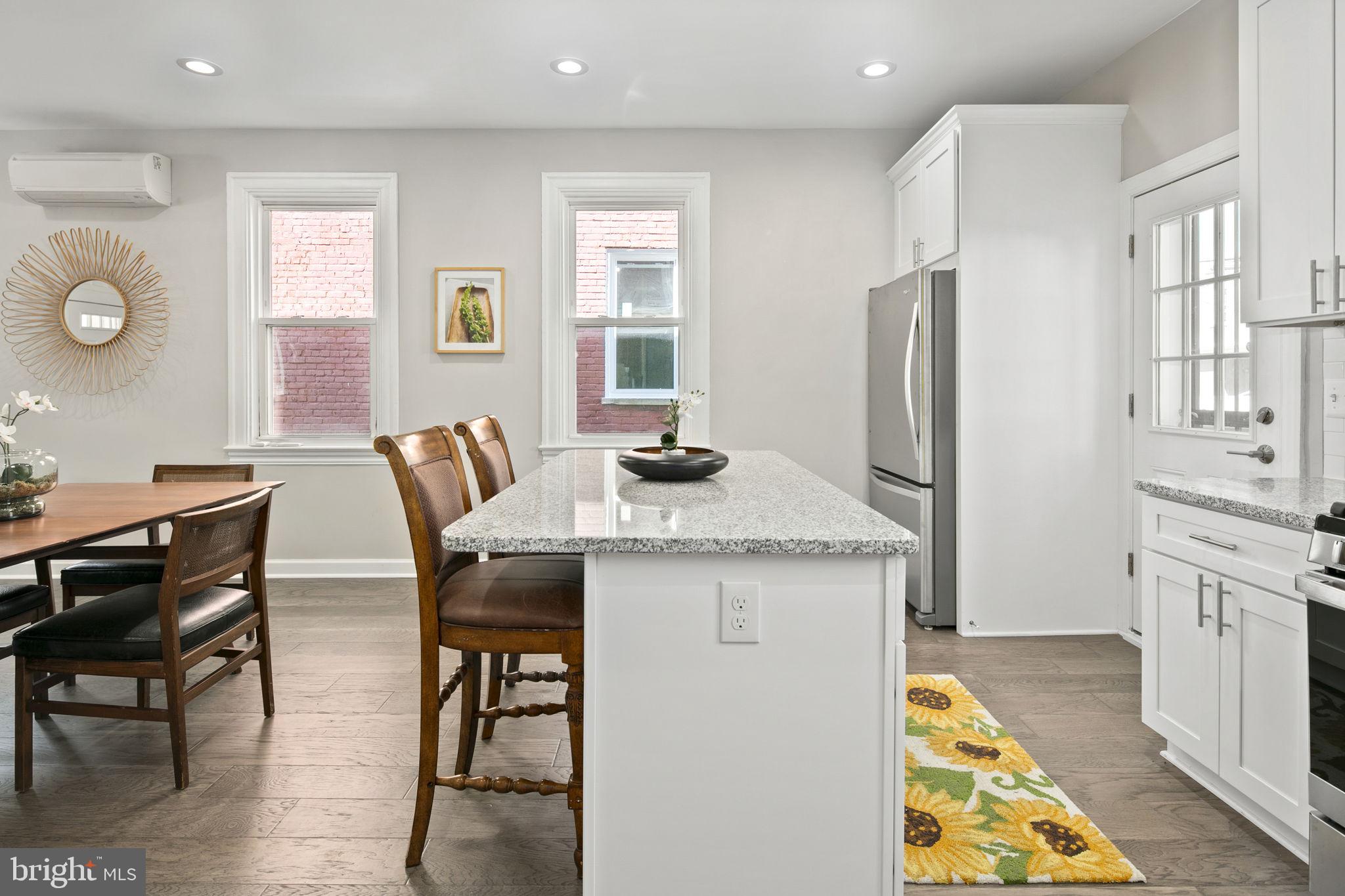 713 Rittenhouse Street Northwest Washington, DC 20011 - Photo 22 of 35 a kitchen with stainless steel appliances granite countertop a dining table chairs refrigerator and sink