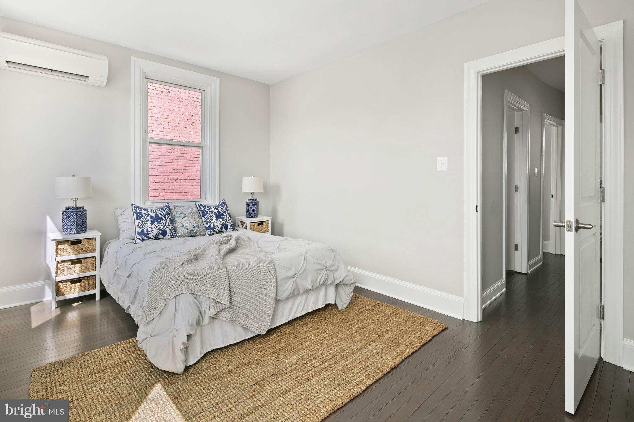 713 Rittenhouse Street Northwest Washington, DC 20011 - Photo 23 of 35 a bedroom with a bed and wooden floor