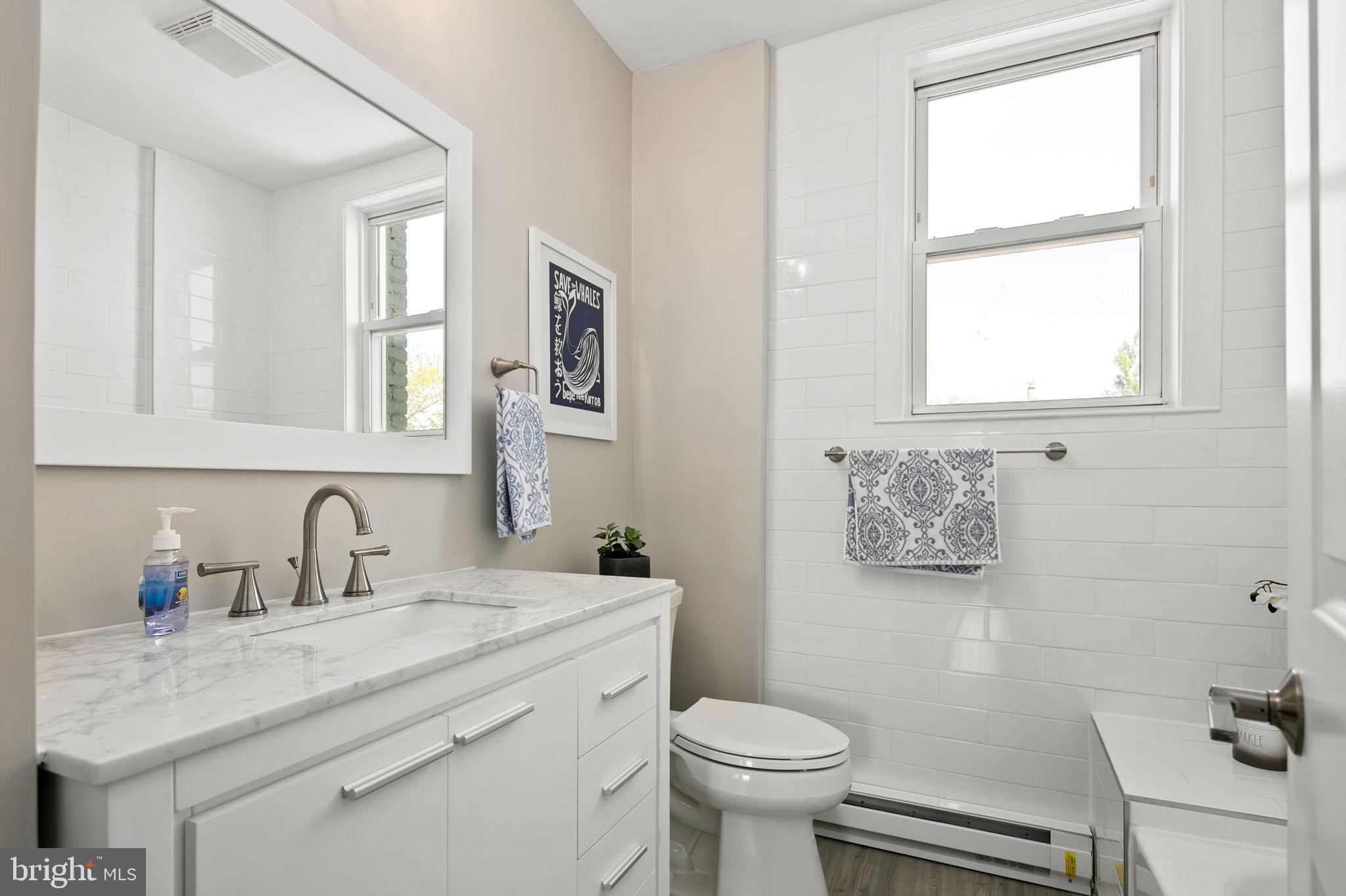 713 Rittenhouse Street Northwest Washington, DC 20011 - Photo 26 of 35 a bathroom with a toilet sink and mirror