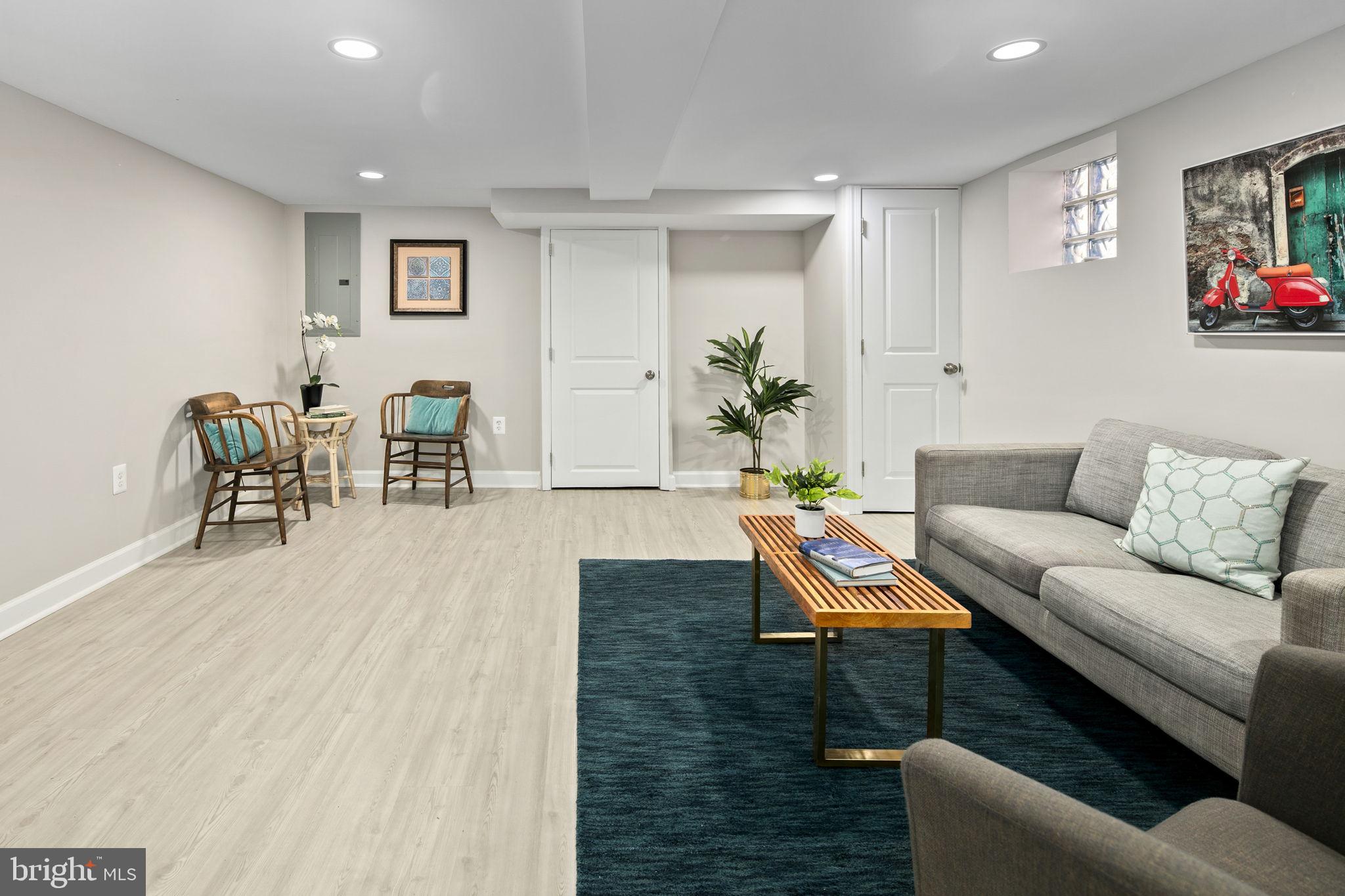 713 Rittenhouse Street Northwest Washington, DC 20011 - Photo 31 of 35 a living room with furniture and a dining table with wooden floor