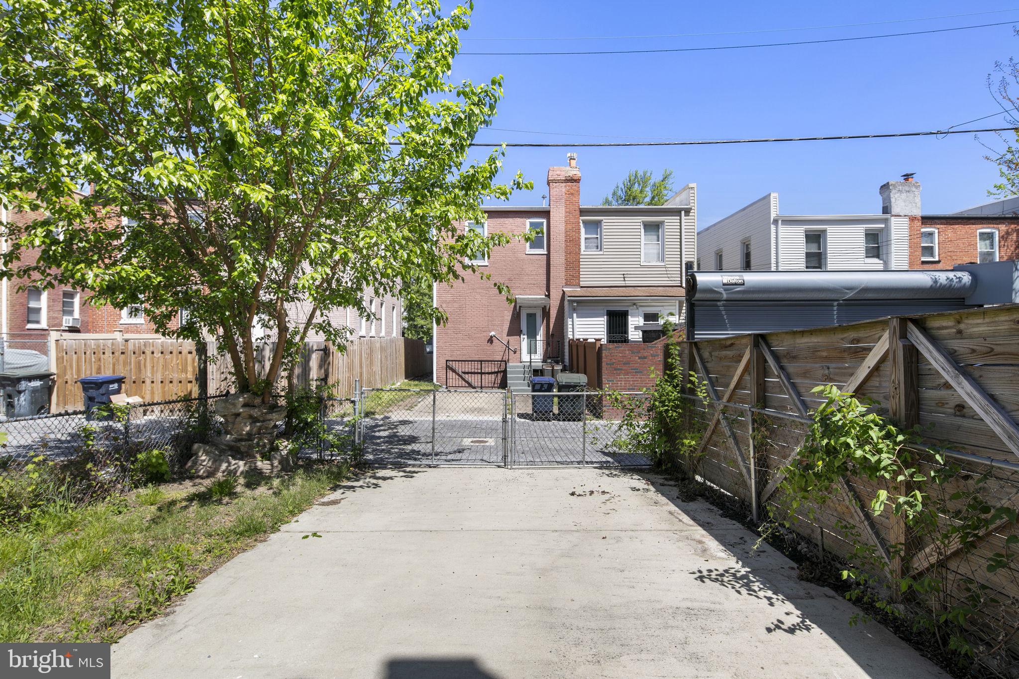 713 Rittenhouse Street Northwest Washington, DC 20011 - Photo 34 of 35 a view of a brick house with many windows plants and large tree