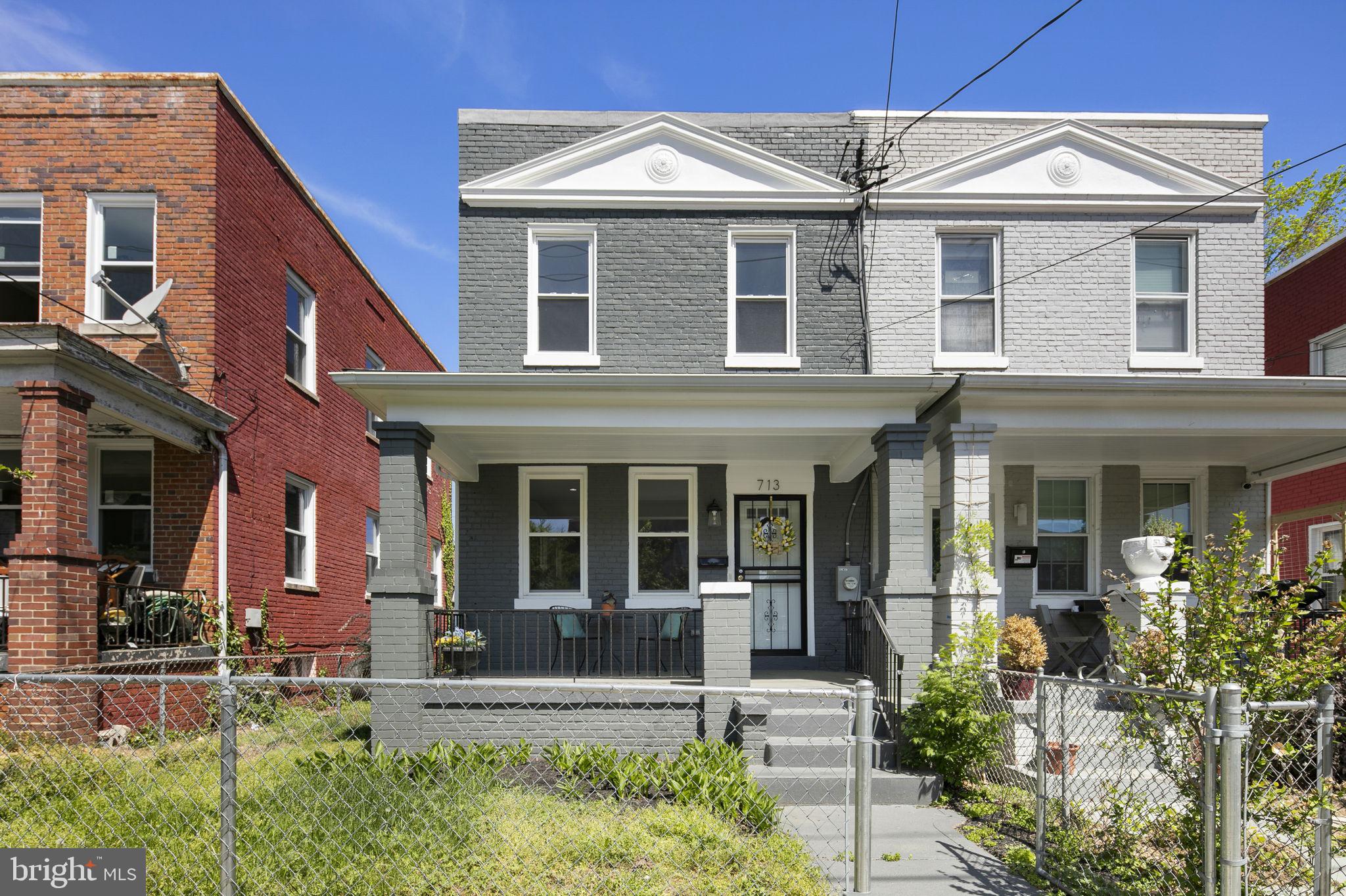 713 Rittenhouse Street Northwest Washington, DC 20011 - Photo 35 of 35 front view of a brick house with a yard