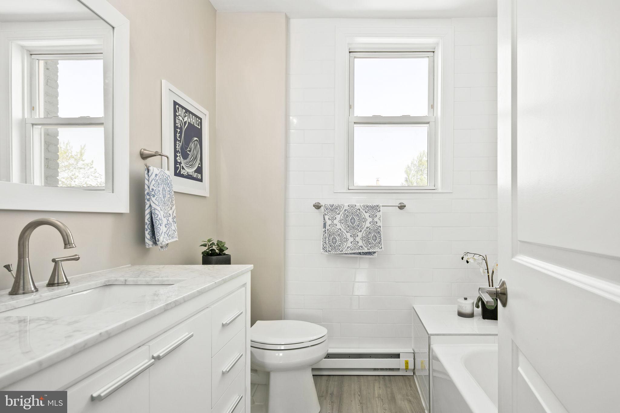 713 Rittenhouse Street Northwest Washington, DC 20011 - Photo 7 of 35 a bathroom with a sink toilet and window