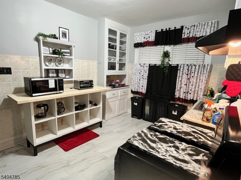42 Harding Terrace Newark, NJ 07112 - Photo 4 of 7 a bedroom with furniture closet and a window
