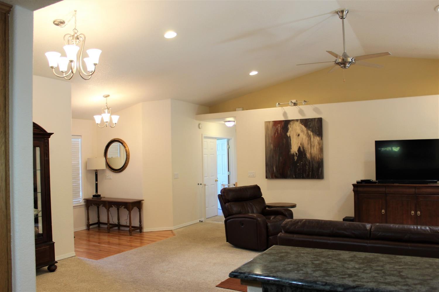 1246 Poppy Ridge Drive Eagle Point, OR 97524 - Photo 7 of 34 a living room with furniture and a flat screen tv