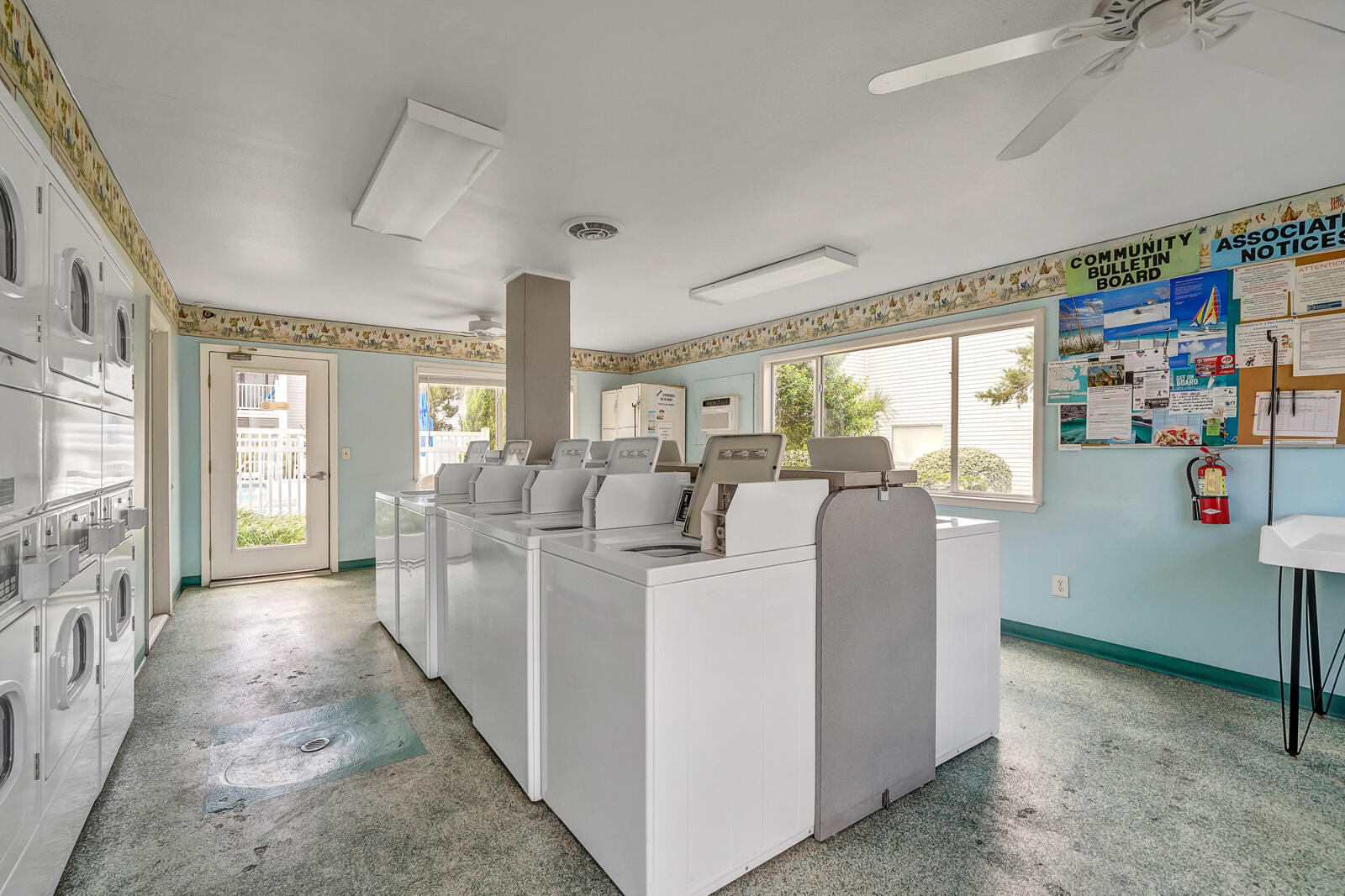 101 Old Ferry Road, Unit 5B Shalimar, FL 32579 - Photo 21 of 22 a living room with furniture a flat screen tv and large windows