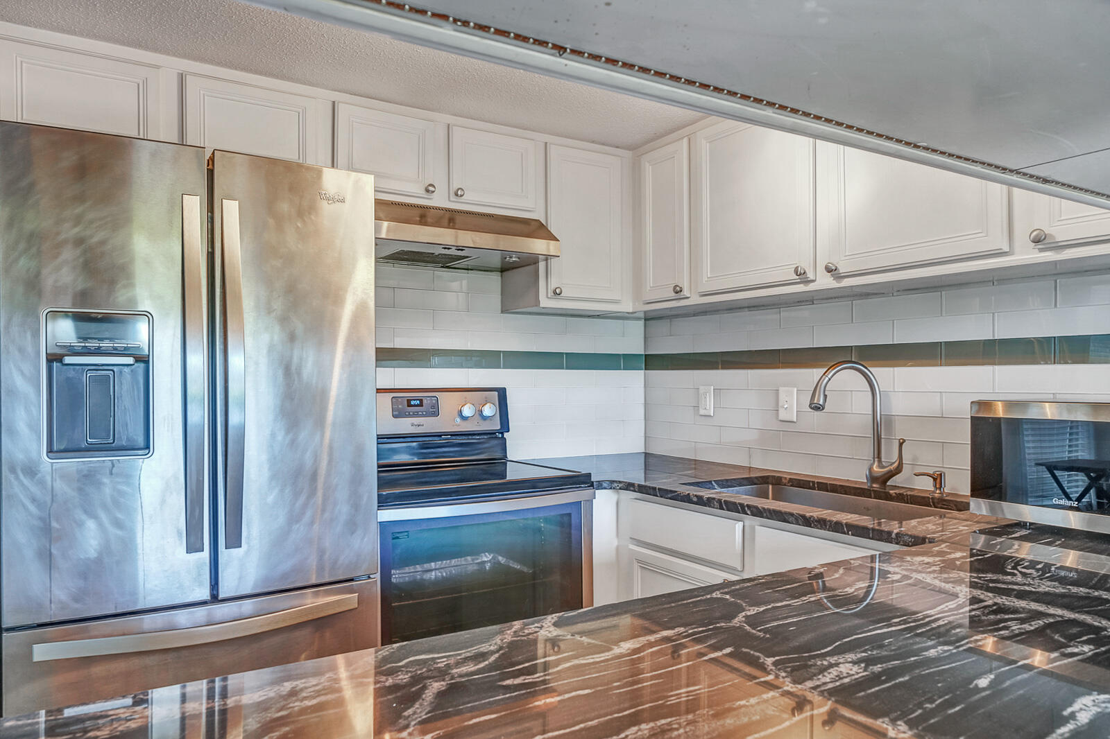 101 Old Ferry Road, Unit 5B Shalimar, FL 32579 - Photo 4 of 22 a kitchen with stainless steel appliances granite countertop a refrigerator and a stove