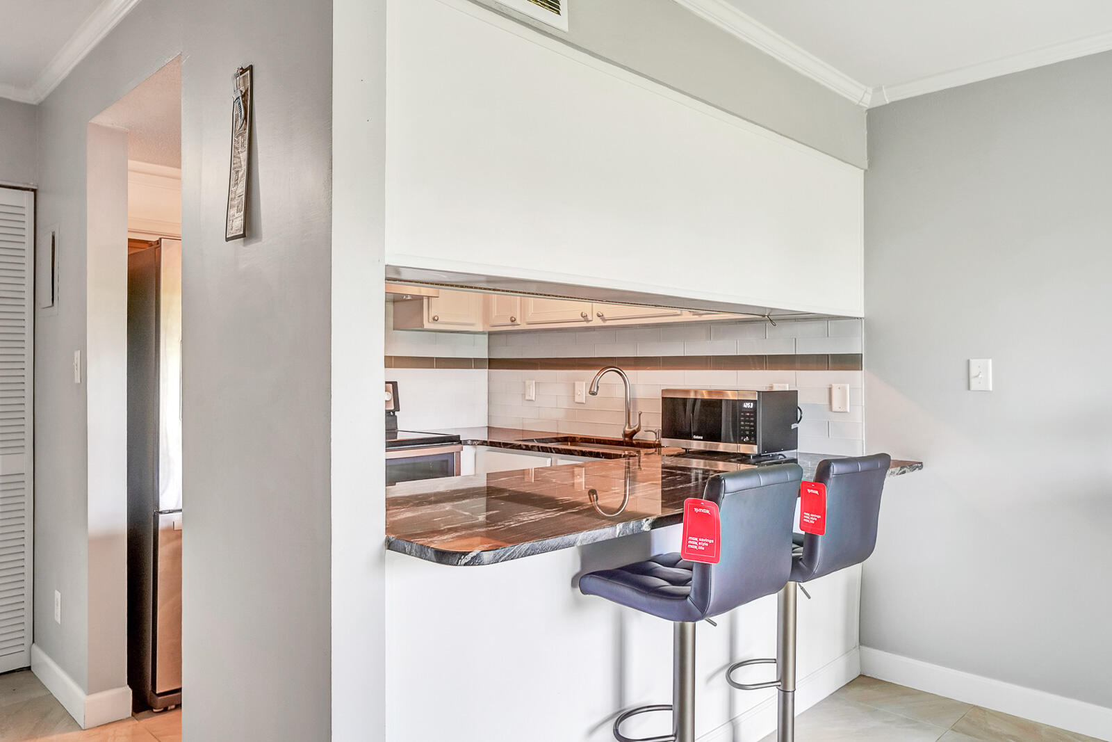 101 Old Ferry Road, Unit 5B Shalimar, FL 32579 - Photo 7 of 22 a kitchen view with stainless steel appliances kitchen island granite countertop a refrigerator and a stove