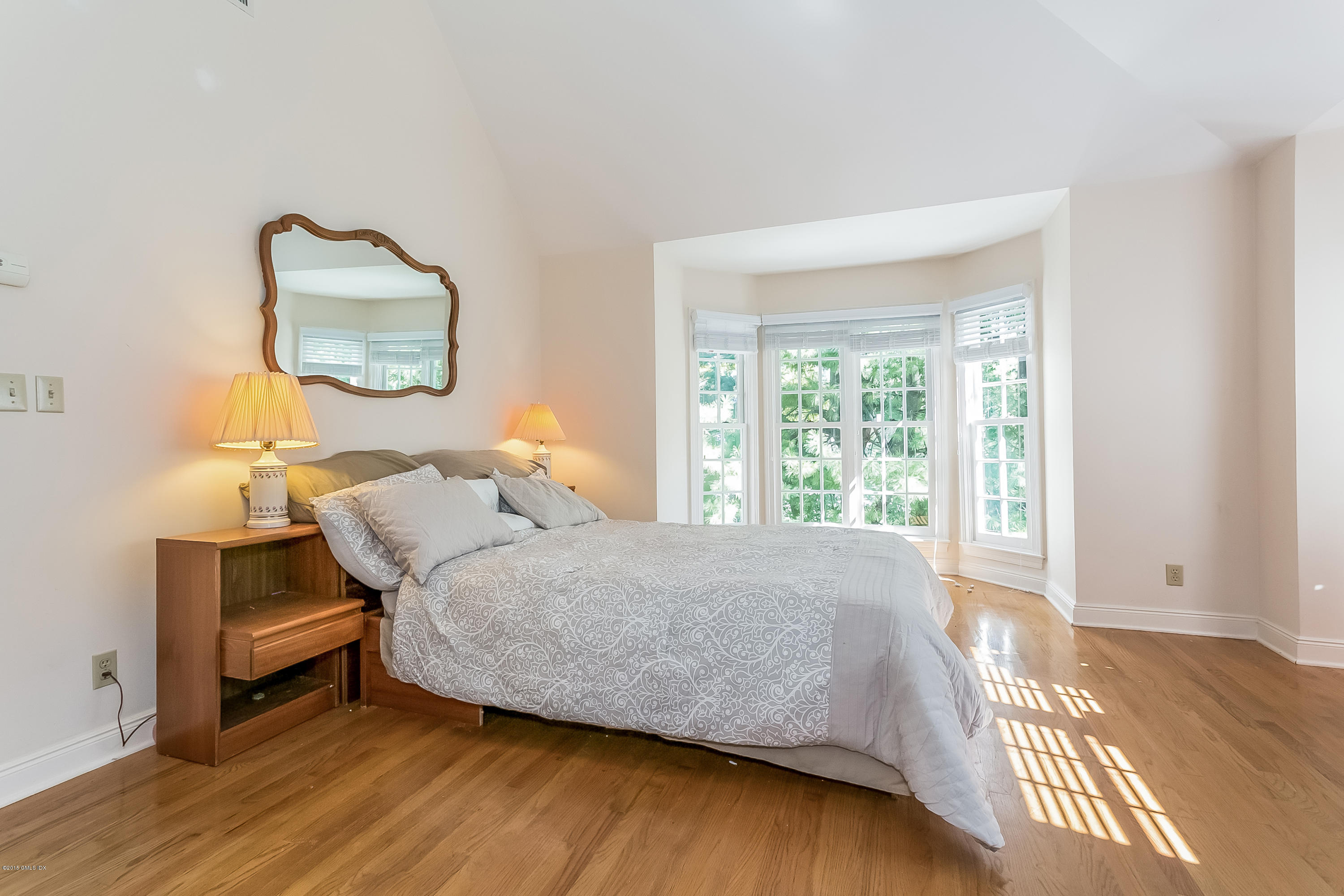 48 Spring Street, Unit 1 Greenwich, CT 06830 - Photo 11 of 18 a bedroom with a bed and wooden floor