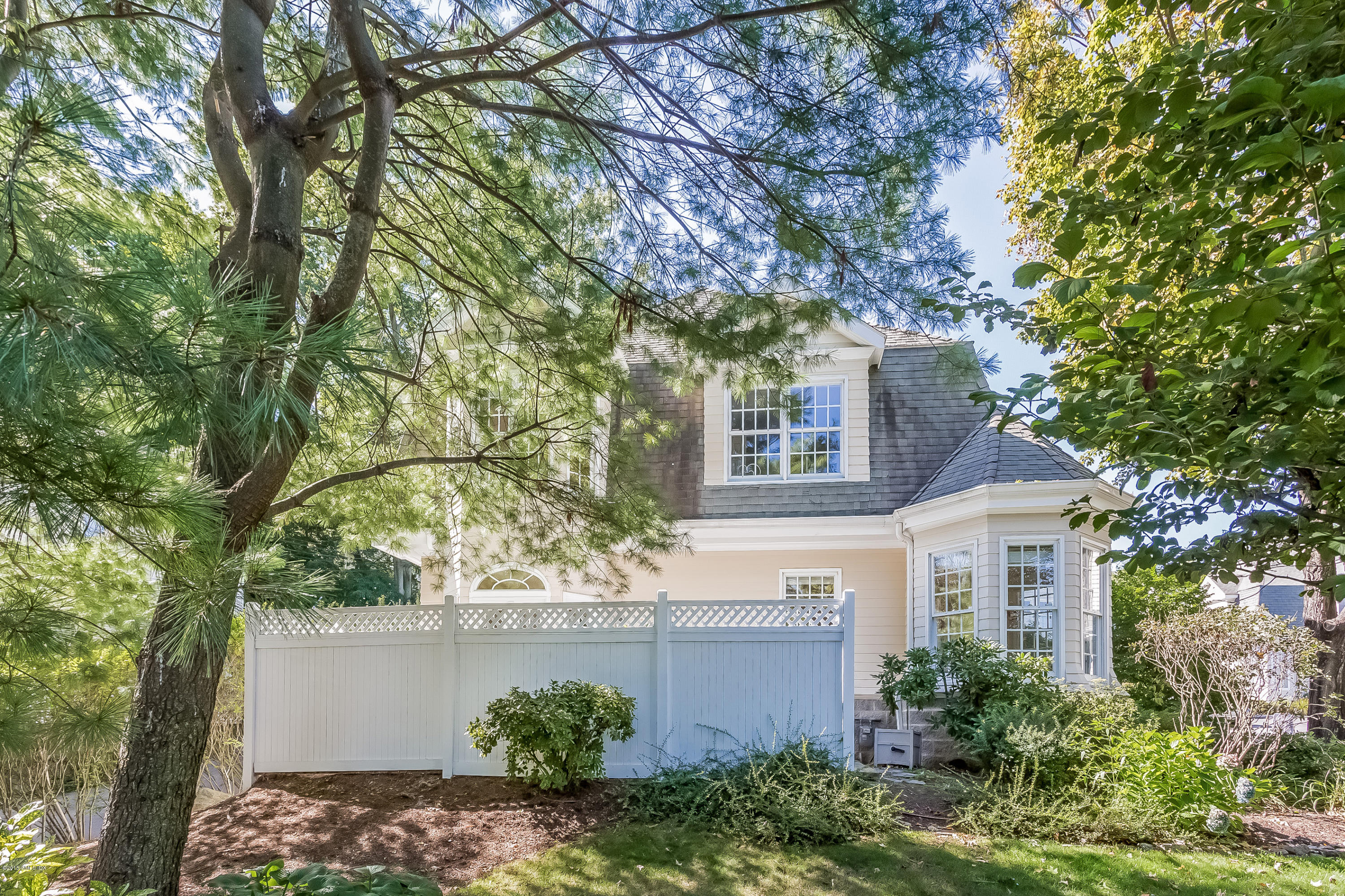 48 Spring Street, Unit 1 Greenwich, CT 06830 - Photo 13 of 18 a front view of a house with a garden