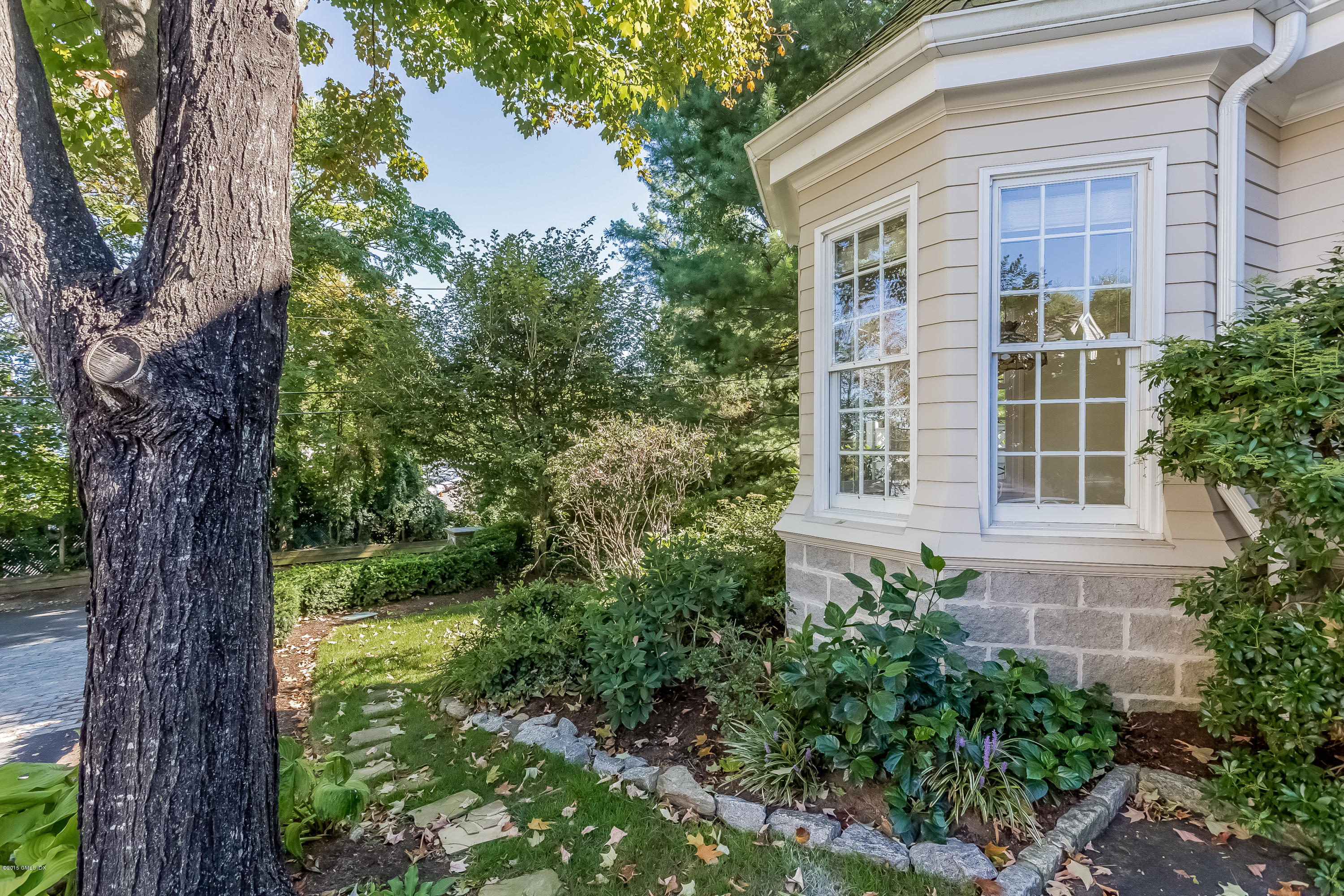 48 Spring Street, Unit 1 Greenwich, CT 06830 - Photo 14 of 18 a view of a house with a tree