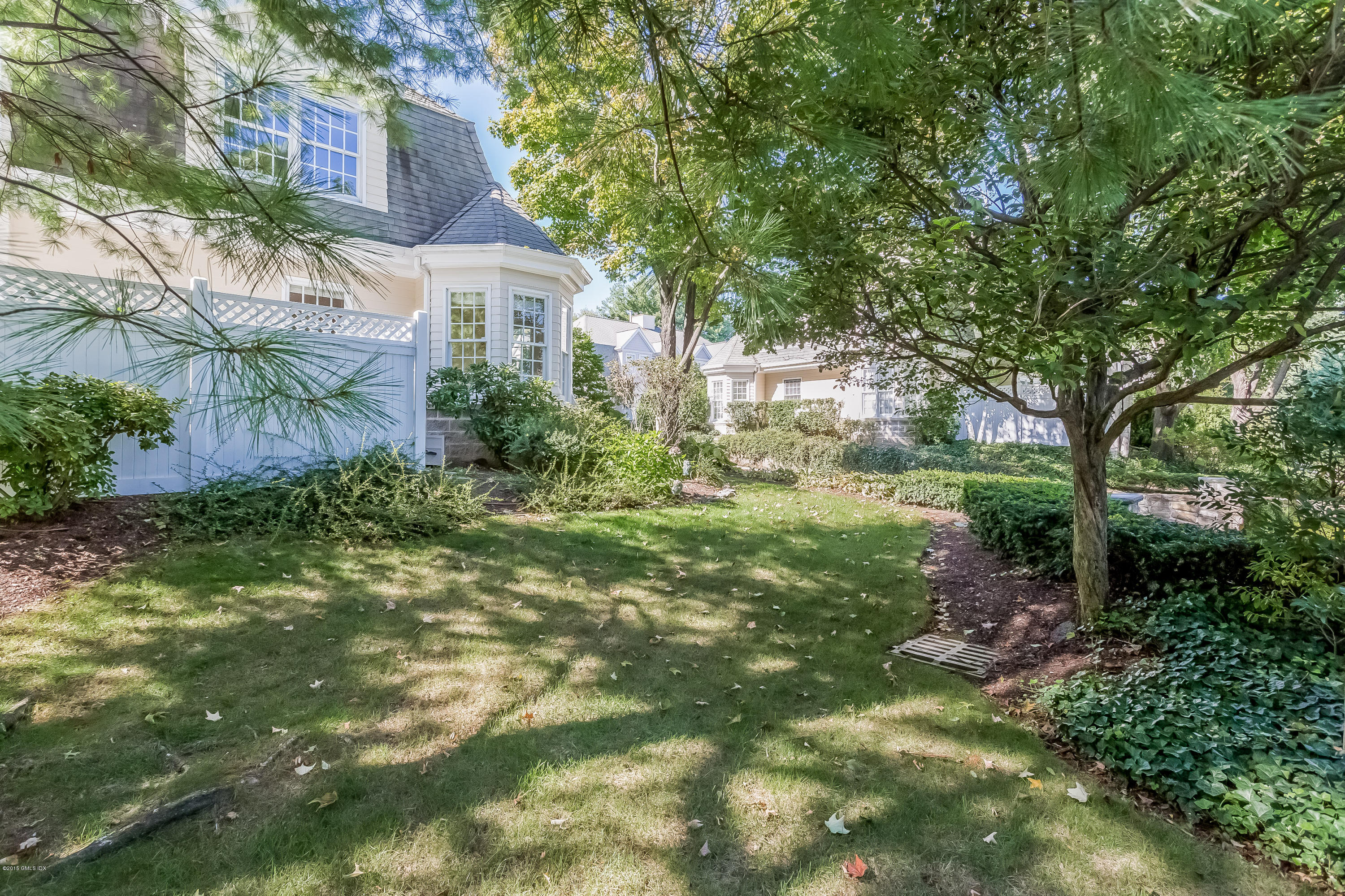 48 Spring Street, Unit 1 Greenwich, CT 06830 - Photo 15 of 18 a view of a house with a yard