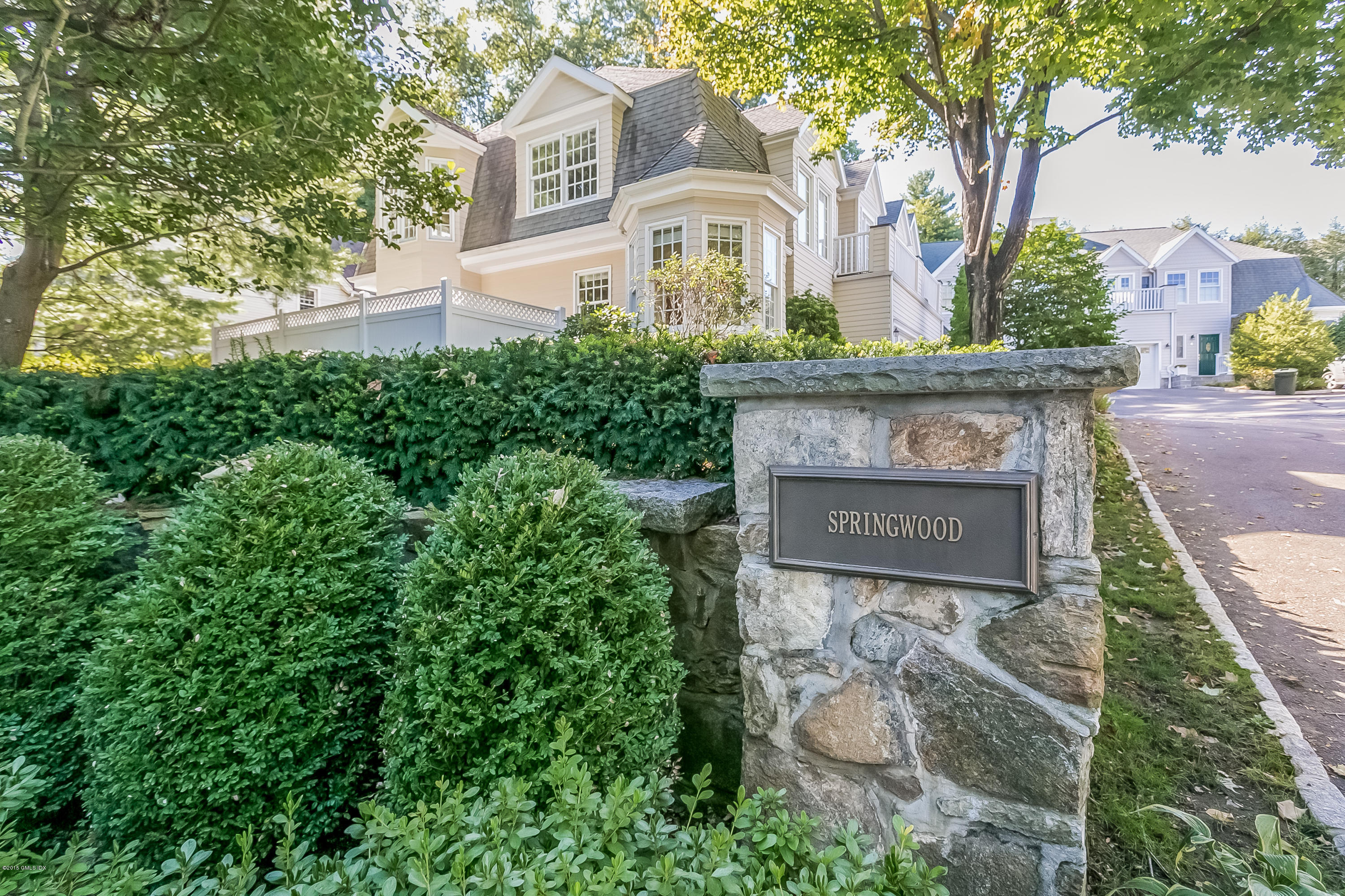 48 Spring Street, Unit 1 Greenwich, CT 06830 - Photo 16 of 18 a front view of a house with garden
