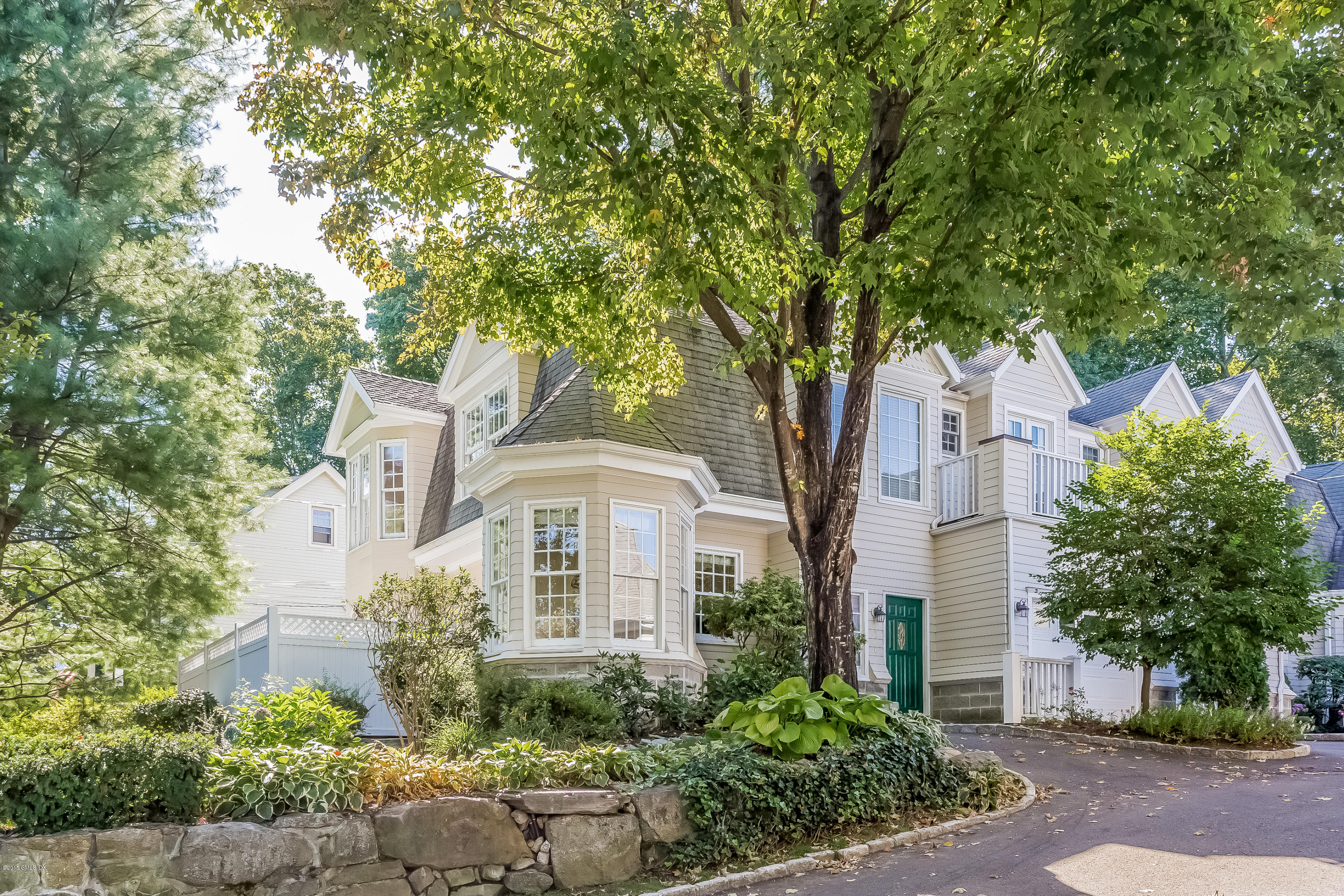 48 Spring Street, Unit 1 Greenwich, CT 06830 - Photo 2 of 18 front view of a house with a tree