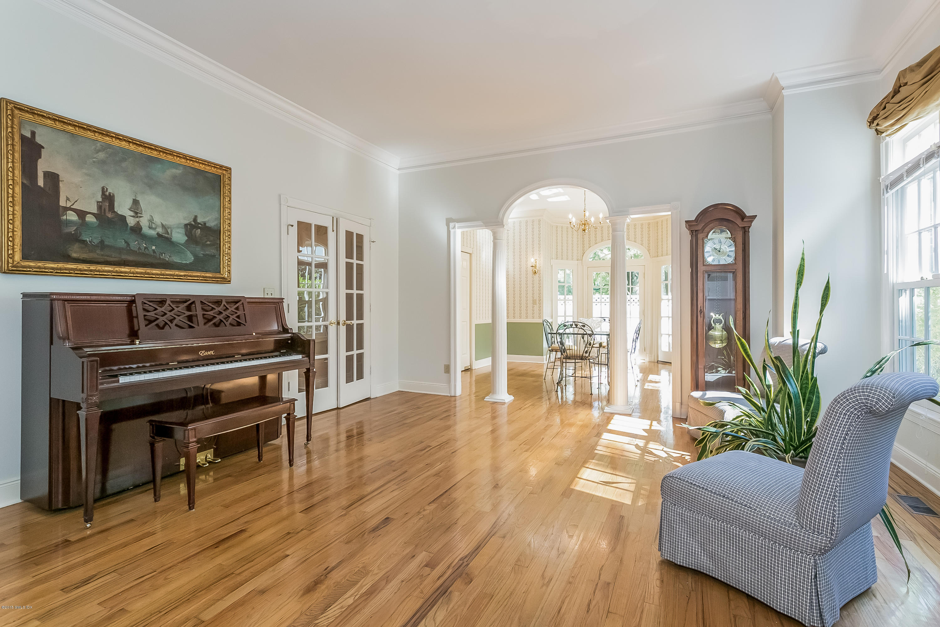 48 Spring Street, Unit 1 Greenwich, CT 06830 - Photo 6 of 18 a living room with furniture and a piano next to a large window