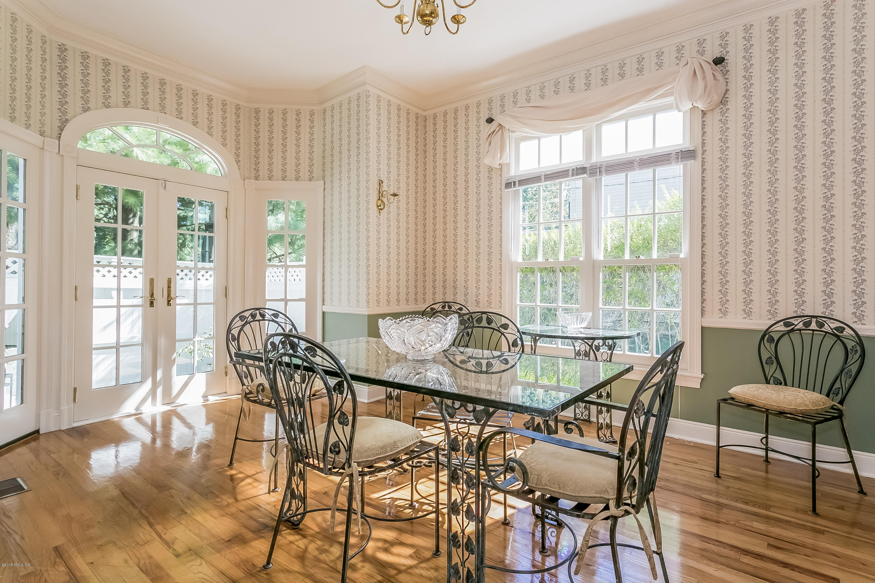 48 Spring Street, Unit 1 Greenwich, CT 06830 - Photo 7 of 18 a view of a dining room with furniture a chandelier and wooden floor