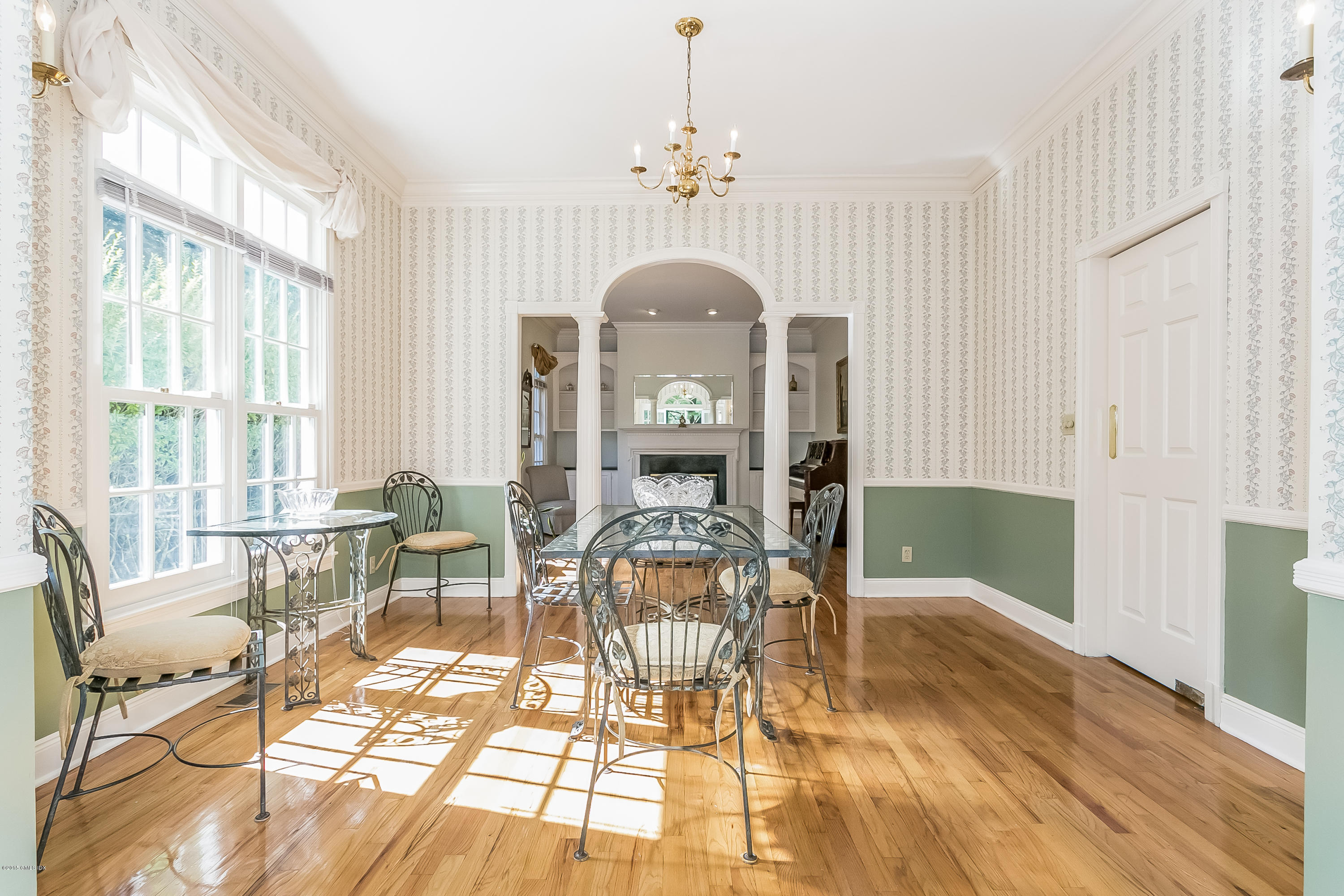 48 Spring Street, Unit 1 Greenwich, CT 06830 - Photo 8 of 18 a view of a dining room with furniture a chandelier and wooden floor