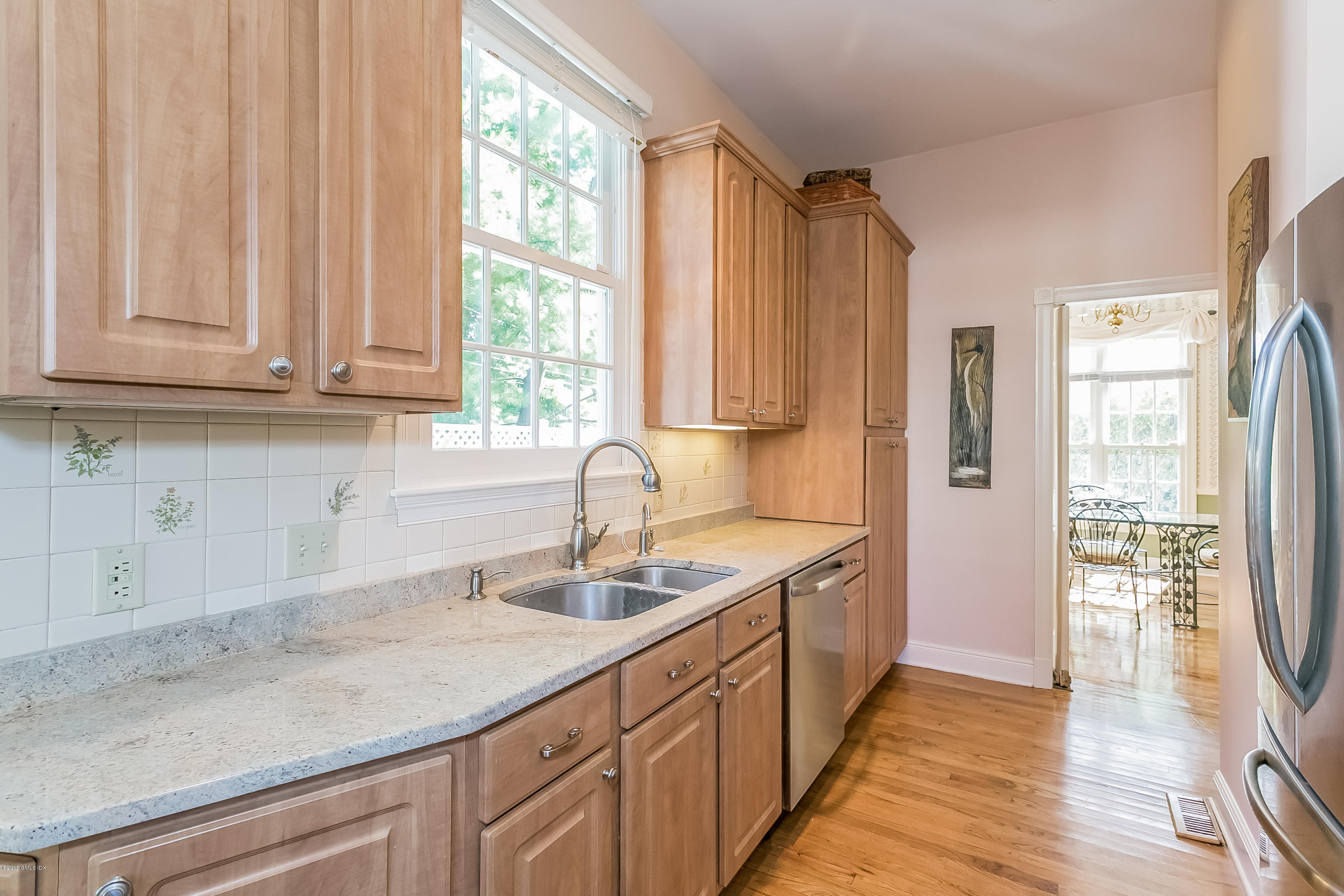 48 Spring Street, Unit 1 Greenwich, CT 06830 - Photo 9 of 18 a kitchen with stainless steel appliances granite countertop a sink and a white cabinets