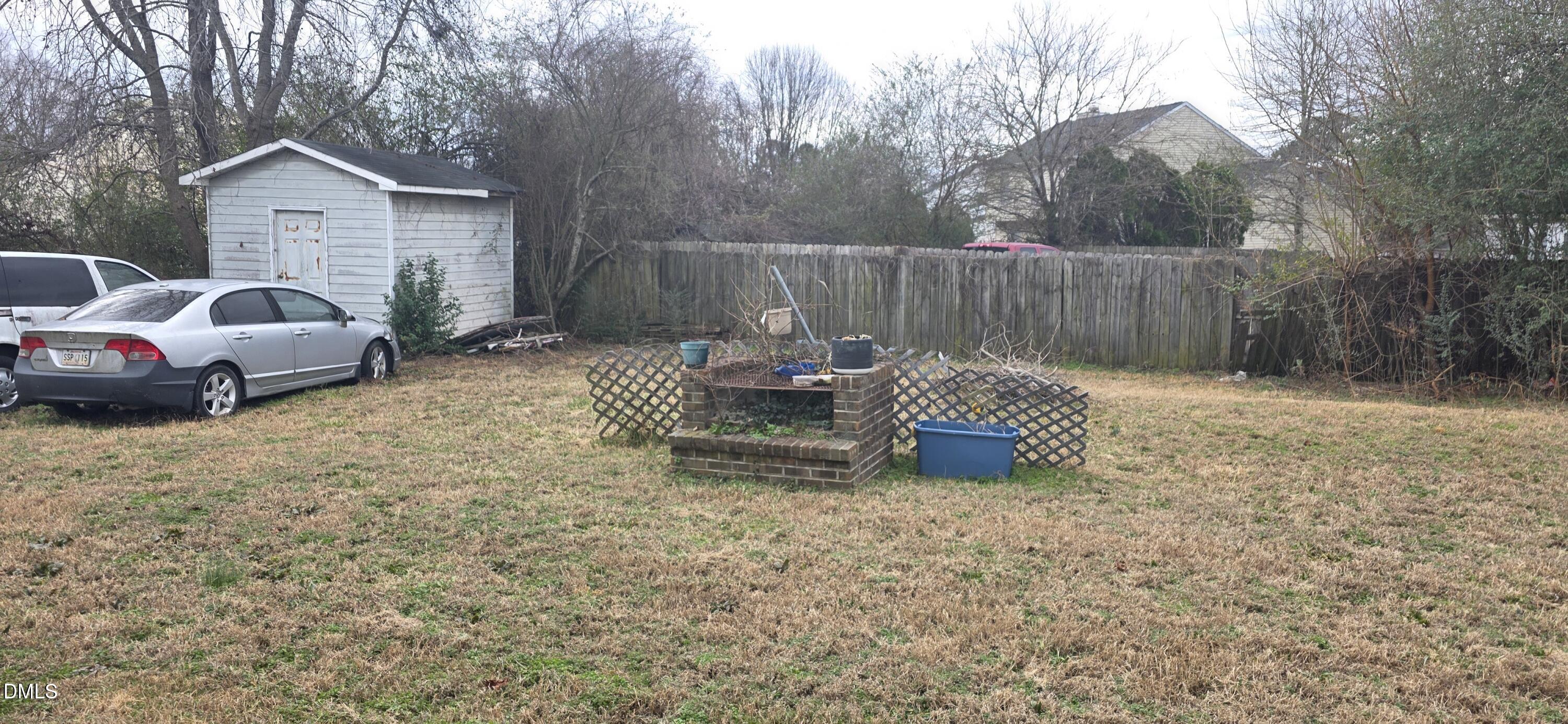 5520 Bellcamp Court Raleigh, NC 27610 - Photo 3 of 7 a view of a backyard with table and chairs and a fire pit