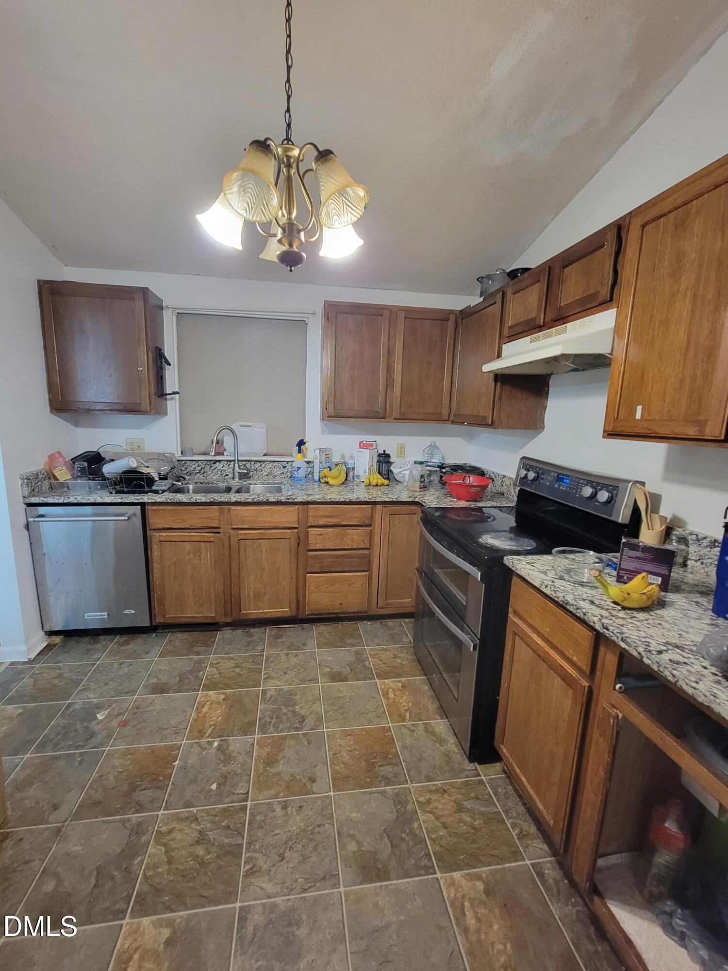 5520 Bellcamp Court Raleigh, NC 27610 - Photo 5 of 7 a kitchen with stainless steel appliances granite countertop a sink a stove and a microwave