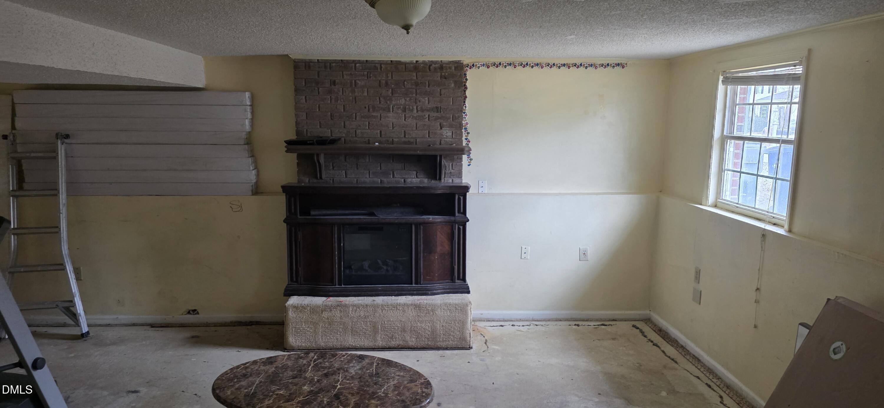 5520 Bellcamp Court Raleigh, NC 27610 - Photo 7 of 7 a living room with a fireplace and a rug