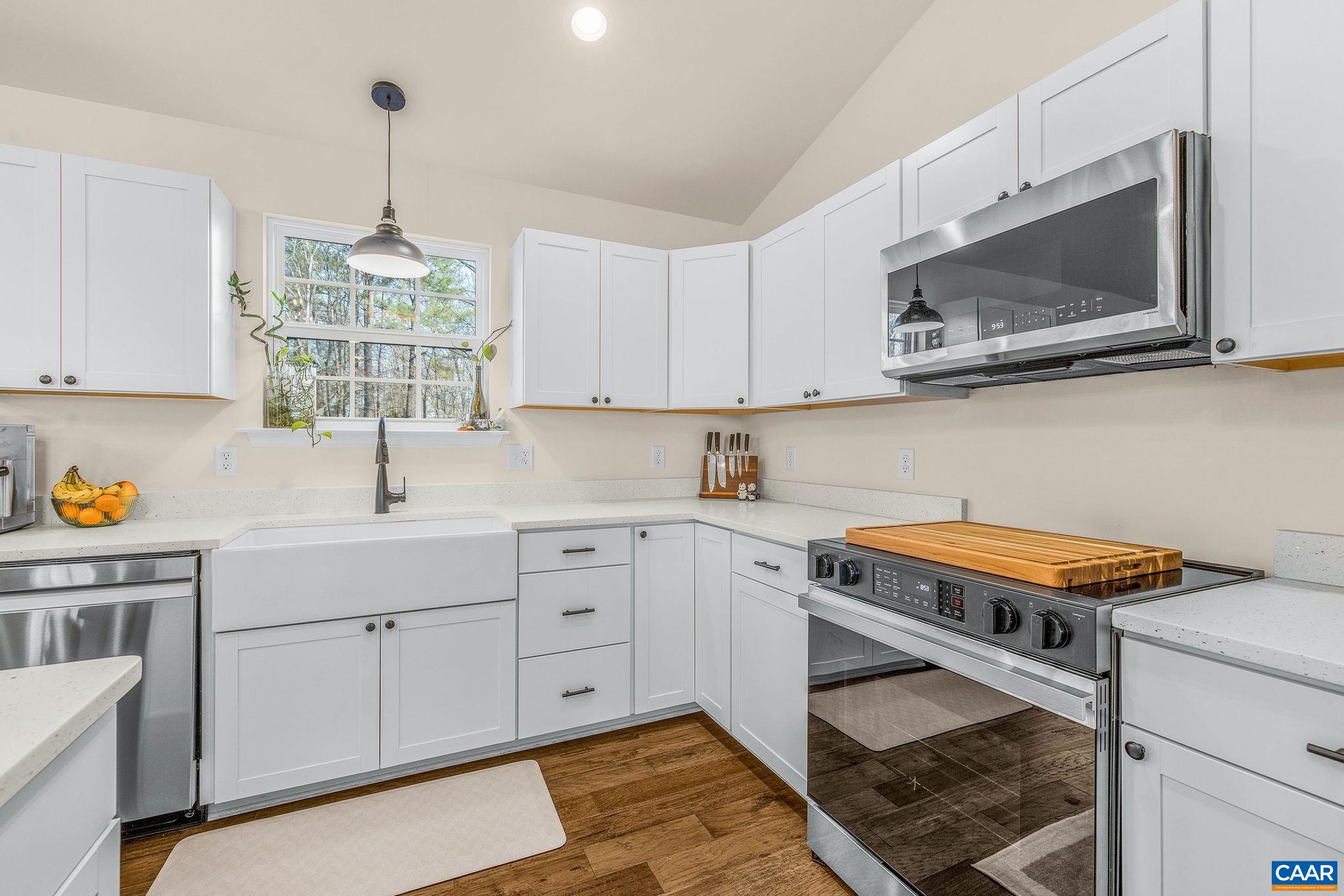 1229 Peach Grove Road Louisa, VA 23093 - Photo 15 of 47 a kitchen with stainless steel appliances a stove sink and microwave