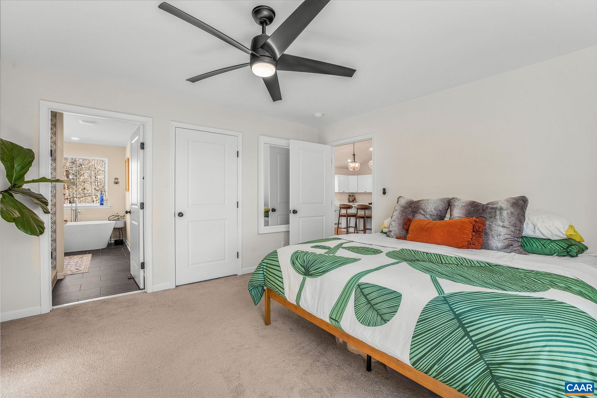 1229 Peach Grove Road Louisa, VA 23093 - Photo 20 of 47 a bedroom with a bed and a chandelier