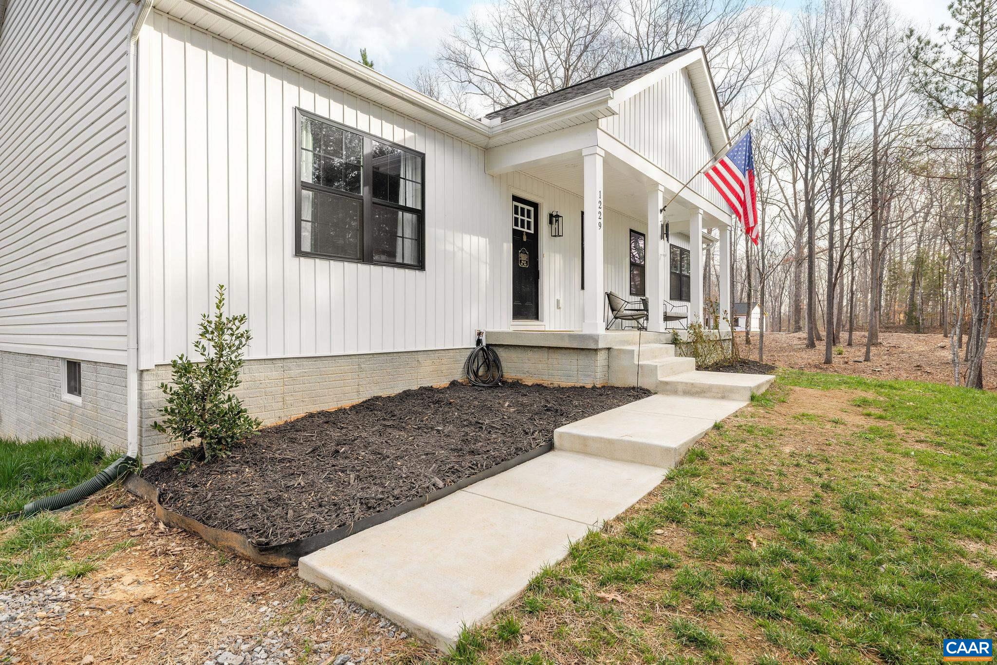 1229 Peach Grove Road Louisa, VA 23093 - Photo 2 of 47 a front view of a house with garden