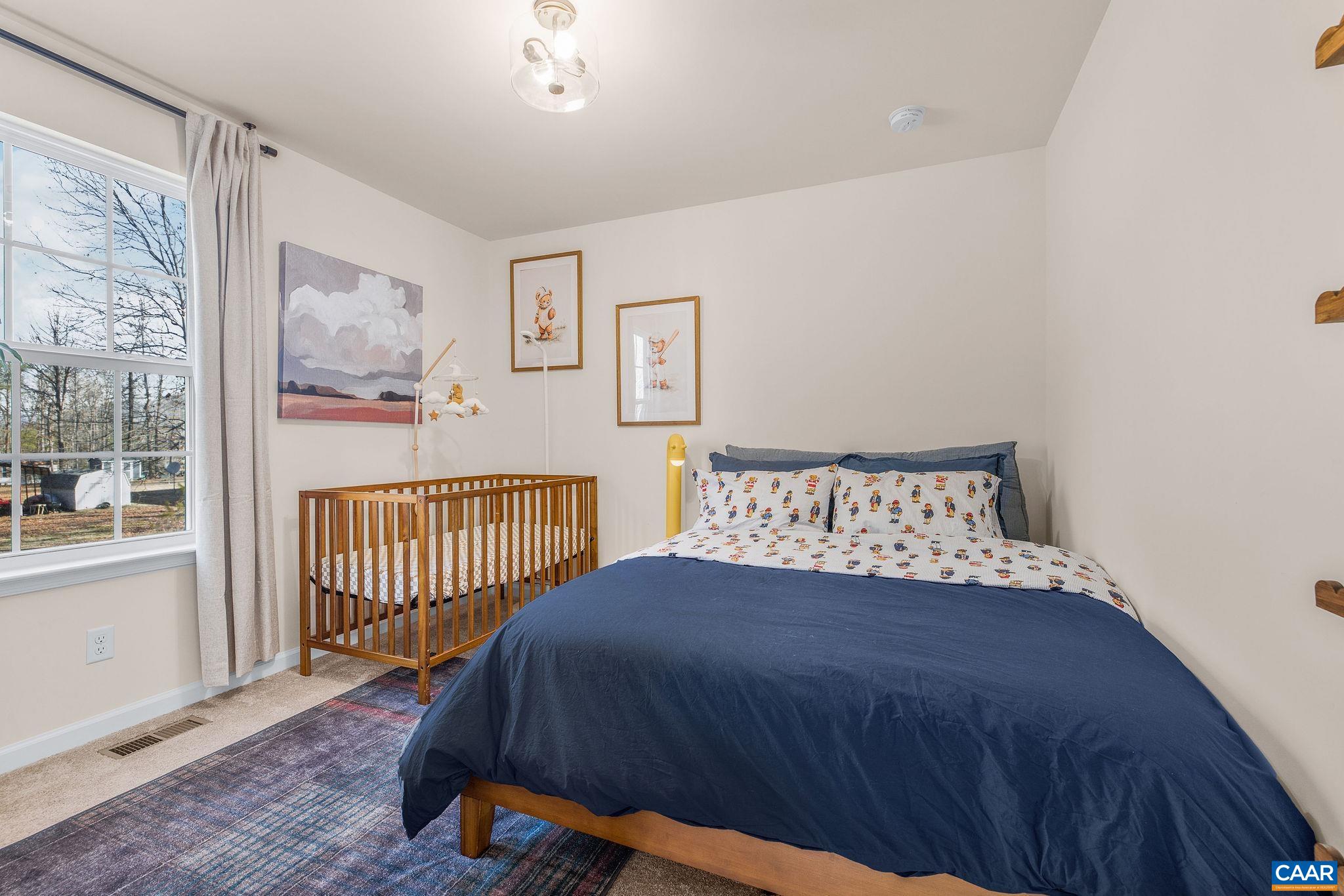 1229 Peach Grove Road Louisa, VA 23093 - Photo 26 of 47 a bedroom with a bed and wooden floor