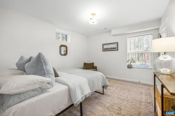 a bedroom with a bed and a lamp on table