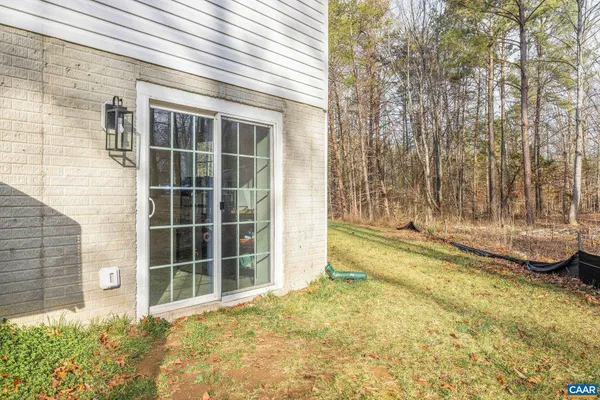 a view of a house with a backyard and floor to ceiling window