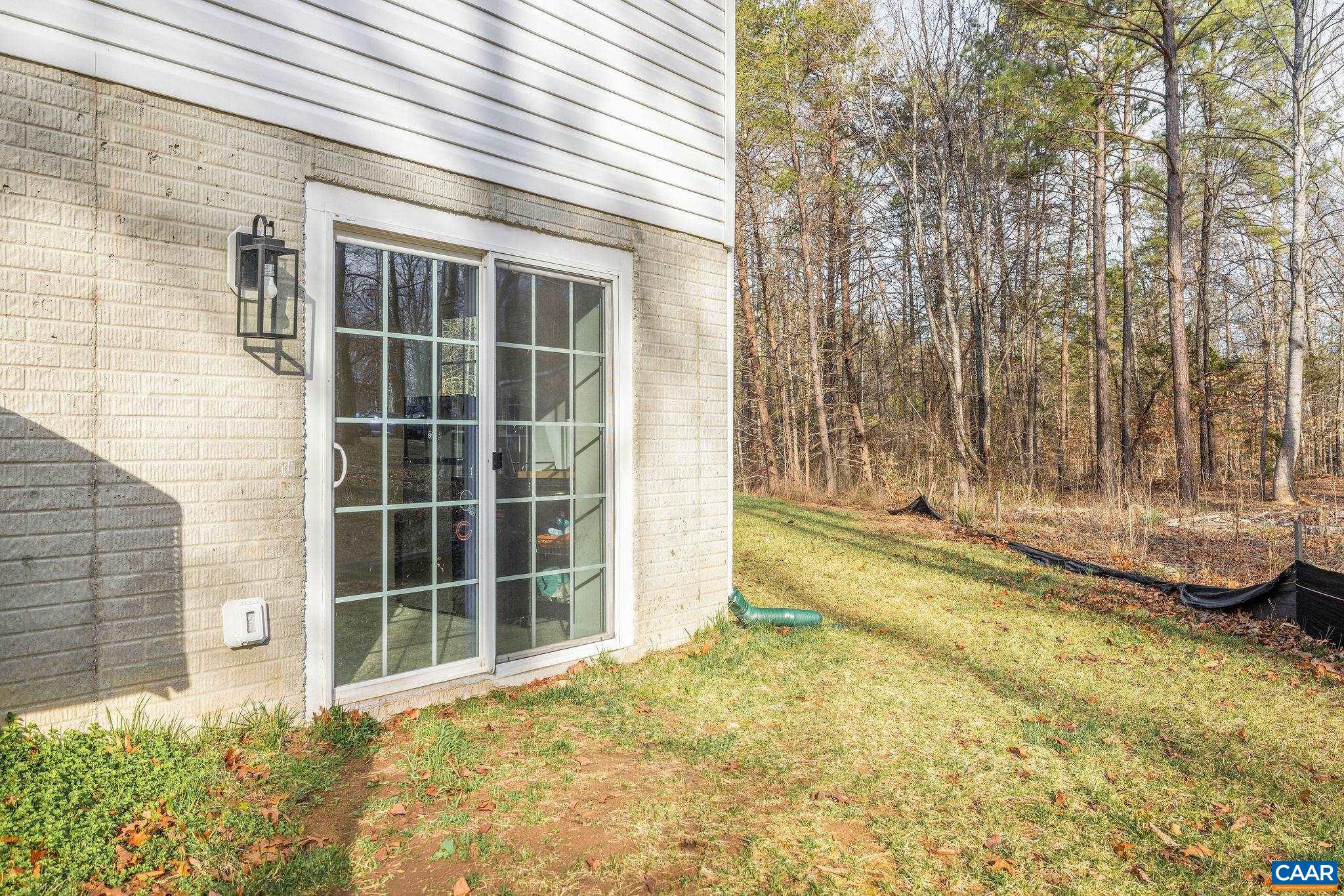 1229 Peach Grove Road Louisa, VA 23093 - Photo 39 of 47 a view of a house with a backyard and floor to ceiling window