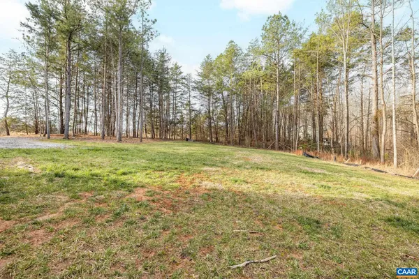 a view of a field with trees in the background