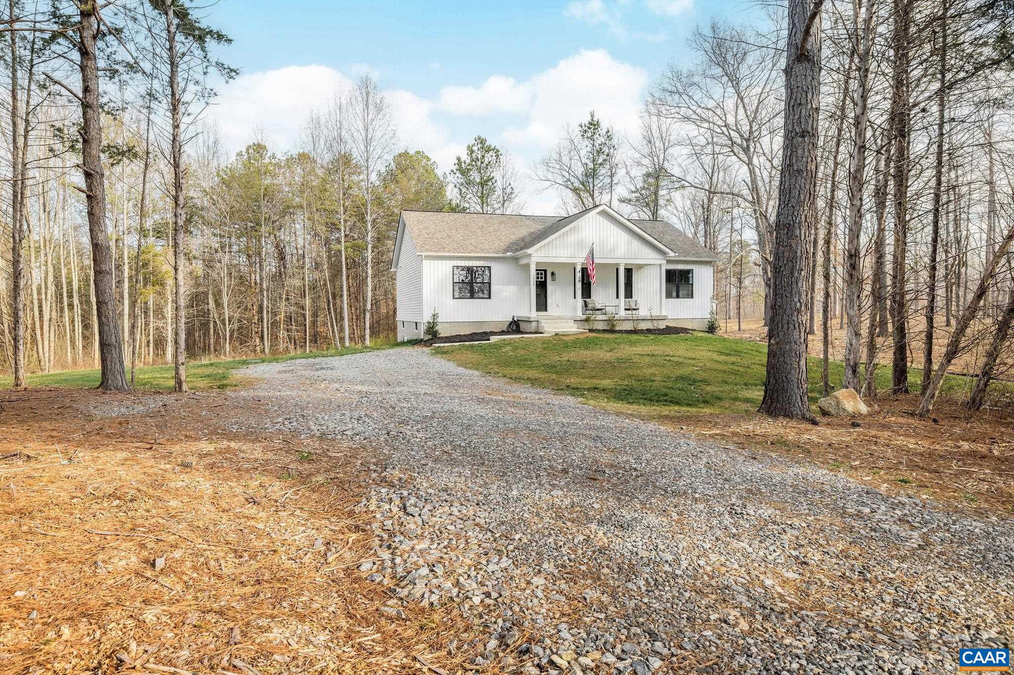 1229 Peach Grove Road Louisa, VA 23093 - Photo 44 of 47 a front view of a house with a yard and trees