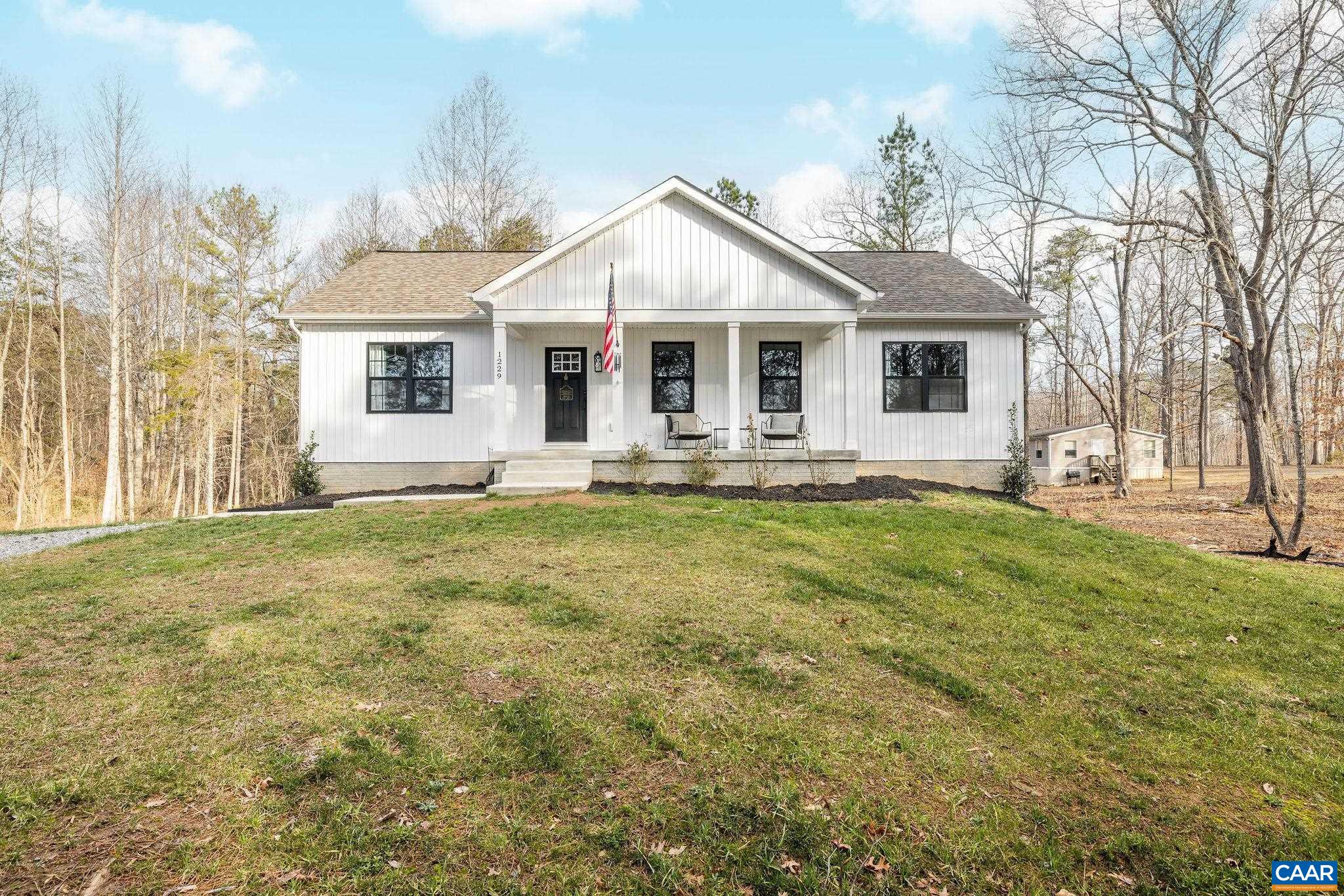 1229 Peach Grove Road Louisa, VA 23093 - Photo 46 of 47 a front view of a house with a yard