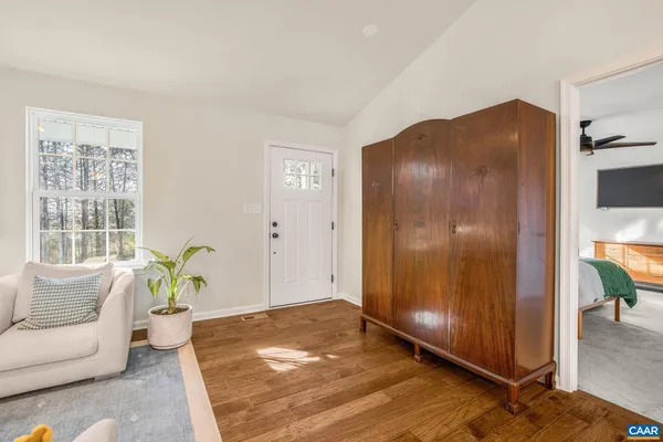 a living room with a couch and a potted plant
